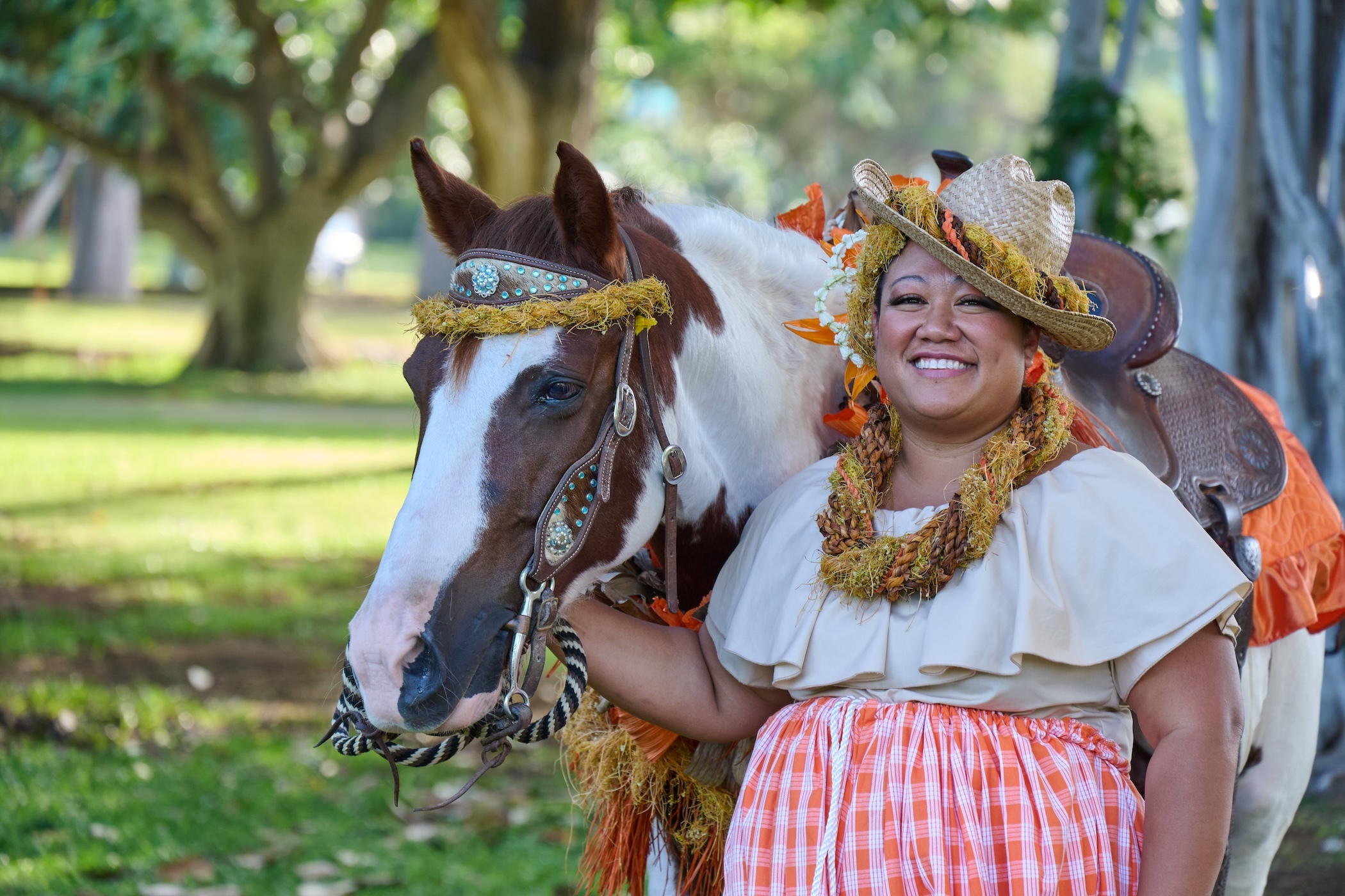 As part of the Aloha Festivals floral parade, men and women on horseback showcase the traditional art of pāʻū riding, while wearing the colors of the different Islands.