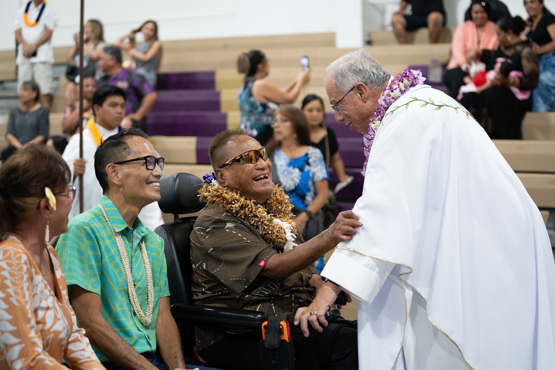 One of two Kalaupapa residents who came to the mass on Sunday greets Very Reverend Monsignor Gary Secor, Vicar General and Moderator of the Curia.