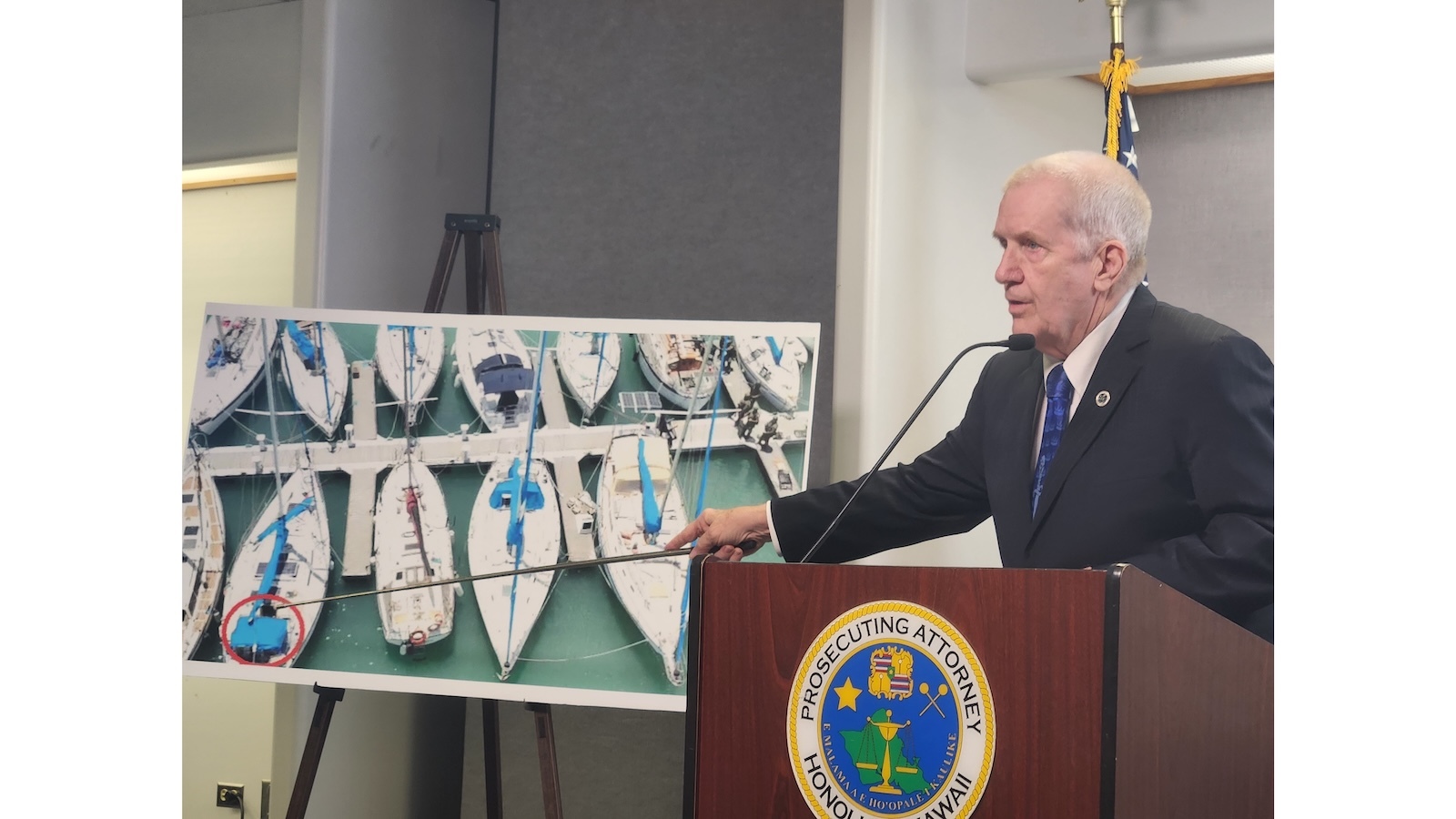 Prosecuting Attorney Steve Alm points at a photograph of Christian Latimore's boat.