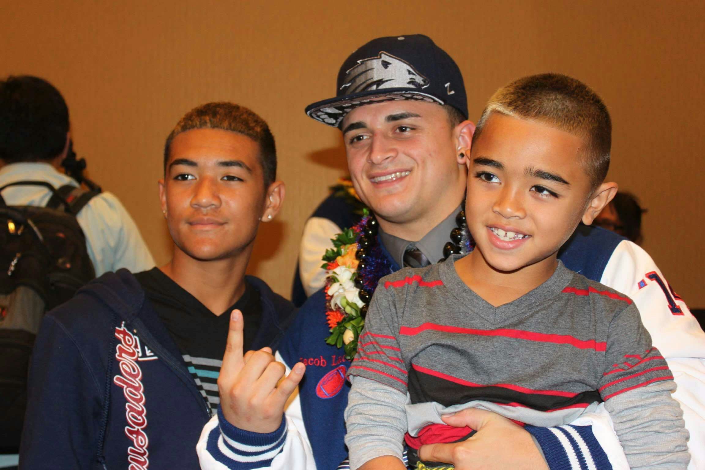 Jake (center) and Titan Lacaden (right) during Jake's National Signing Day with Nevada in 2014 (Photo courtesy Lacaden family).