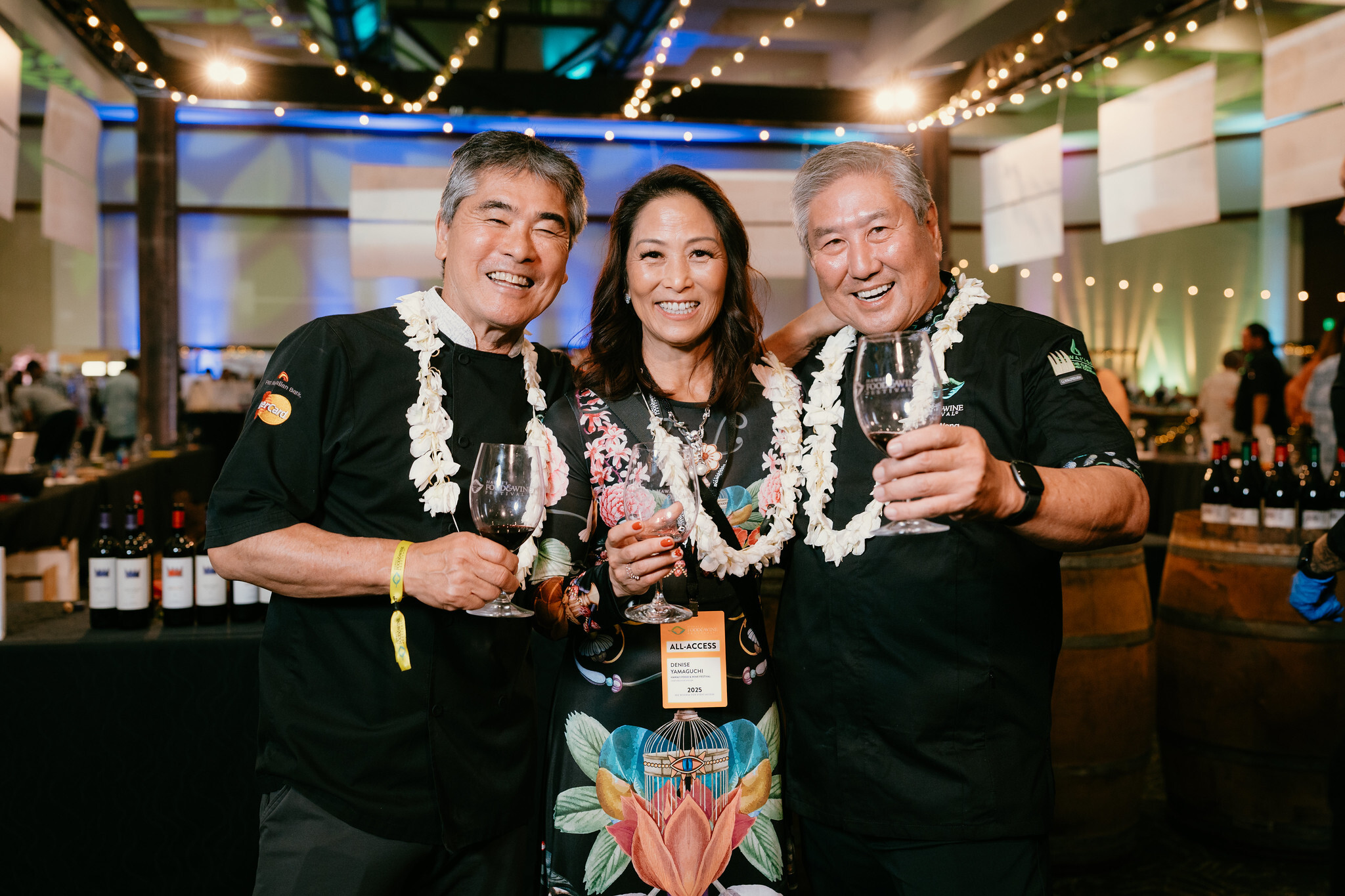 James Beard Award-winning chefs Roy Yamaguchi, left, and Chef Alan Wong, right, stand on either side of Denise Yamaguchi, chief executive officer of Hawai‘i Food & Wine Festival.