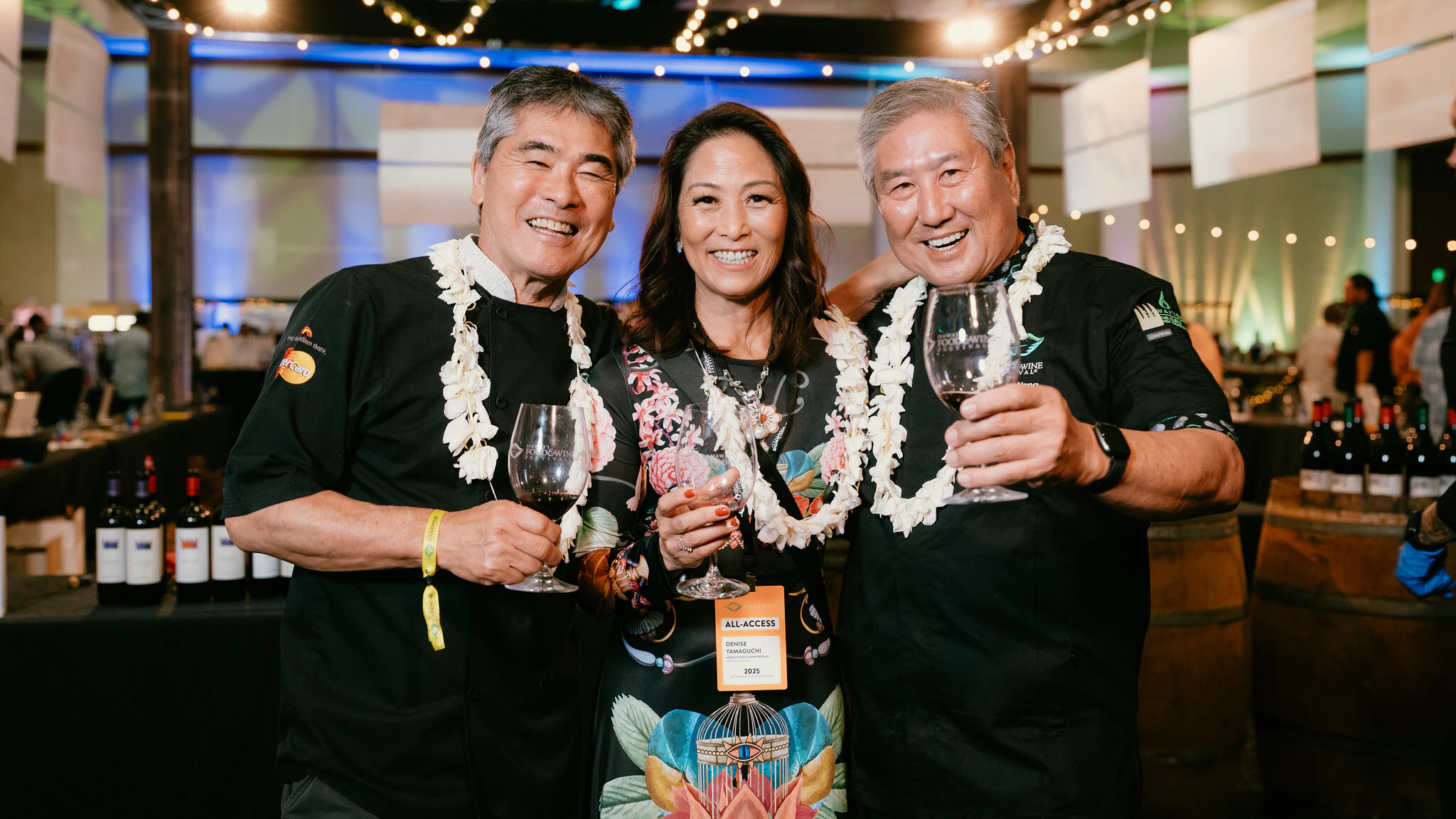 James Beard Award-winning chefs Roy Yamaguchi, left, and Chef Alan Wong, right, stand on either side of Denise Yamaguchi, chief executive officer of Hawai‘i Food & Wine Festival.