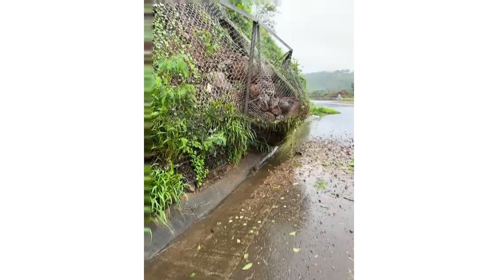 A landslide mostly contained along Kamehameha Highway near Kīpapa Gulch.
