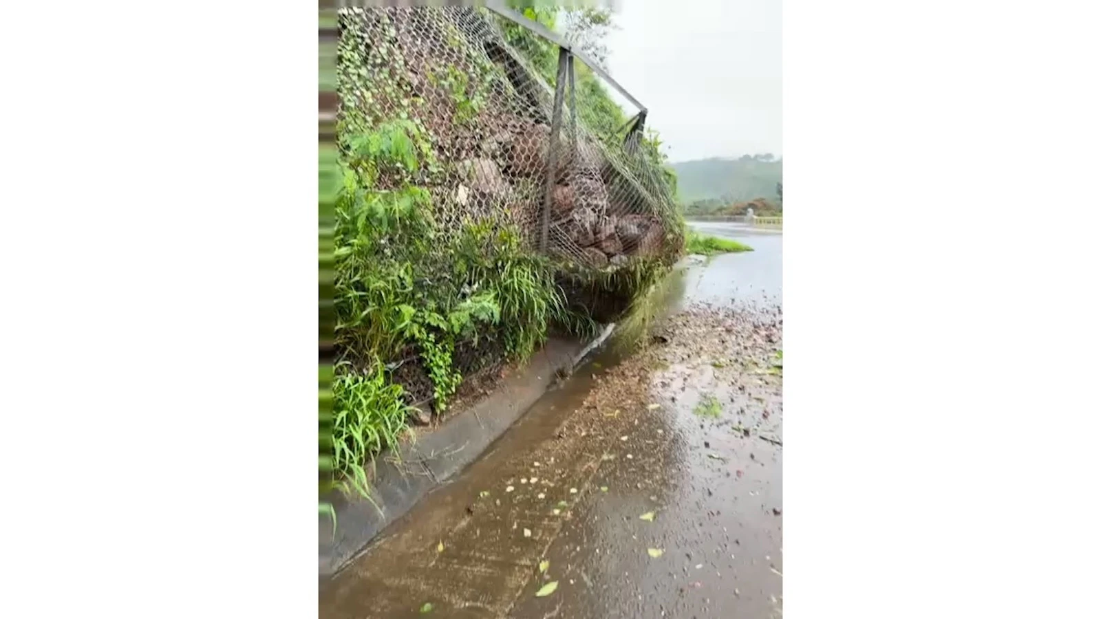 A landslide mostly contained along Kamehameha Highway near Kīpapa Gulch.