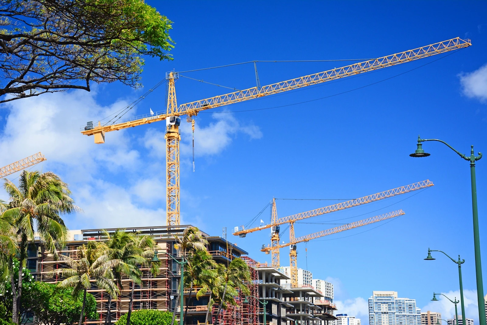 New condo buildings under construction with cranes along Ala Moana Blvd in Honolulu.