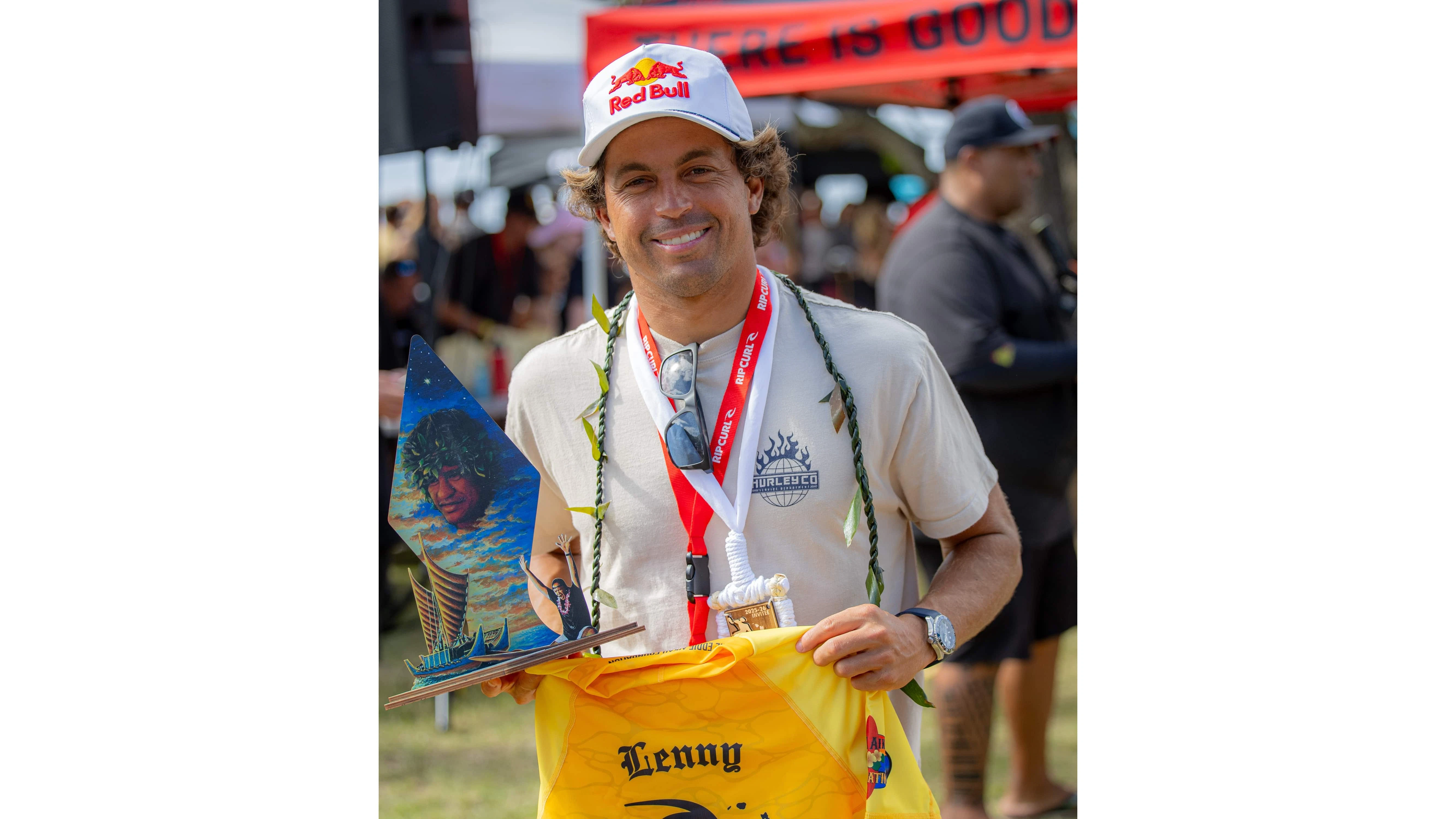 Kai Lenny holds up the trophy designed for invitees by Eddy Y.