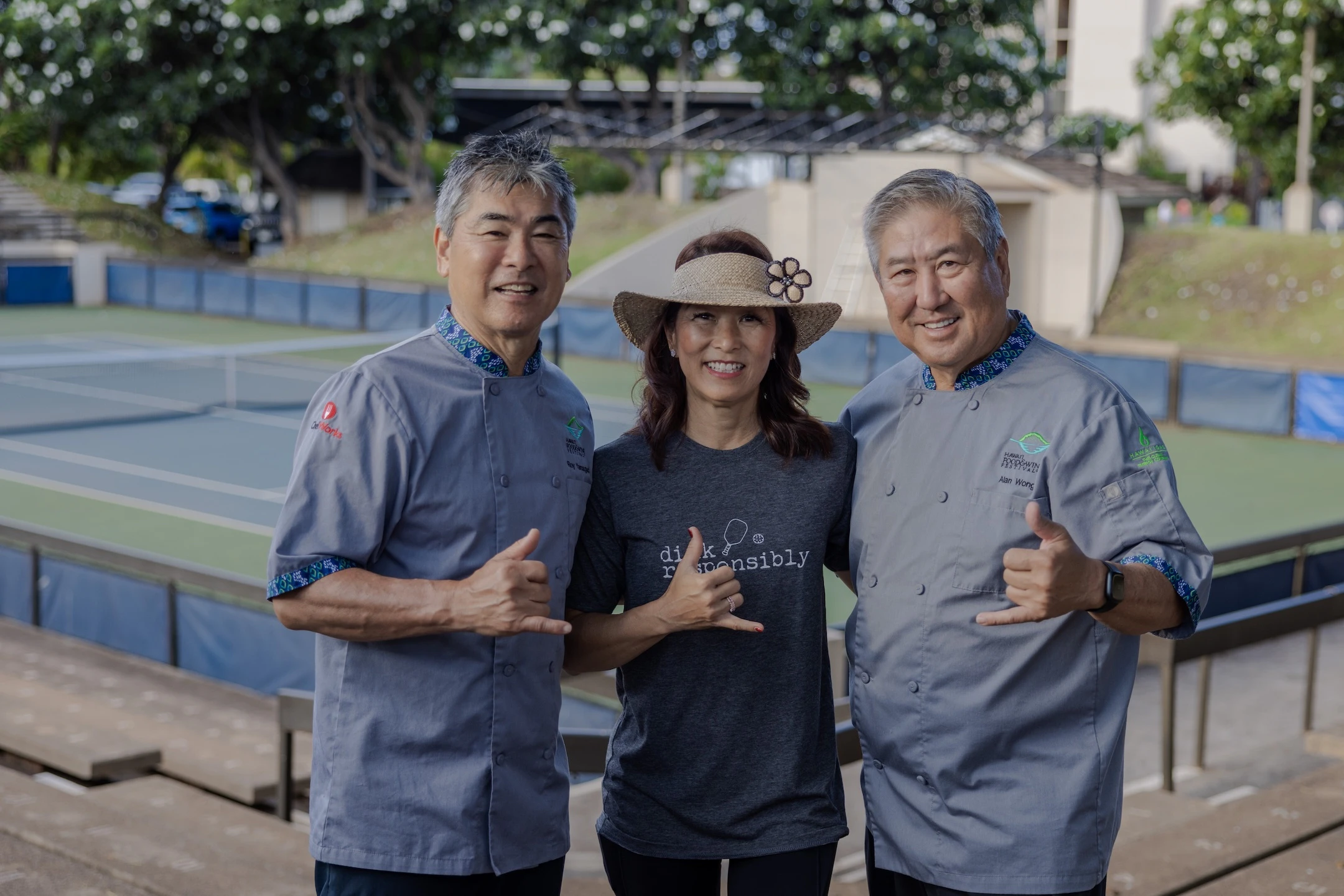 The Hawaiʻi Food & Wine Festival was co-founded by Roy Yamaguchi (left) and Alan Wong (right). The festival is a program of the nonprofit Hawaiʻi Ag & Culinary Alliance, of which Denise Yamaguchi (center) is CEO.