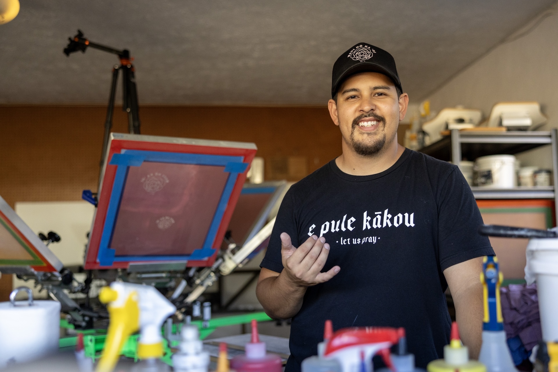 Aloha Ke Akua Clothing Co. owner Jared Nagura pictured at his home screen printing studio on Maui.