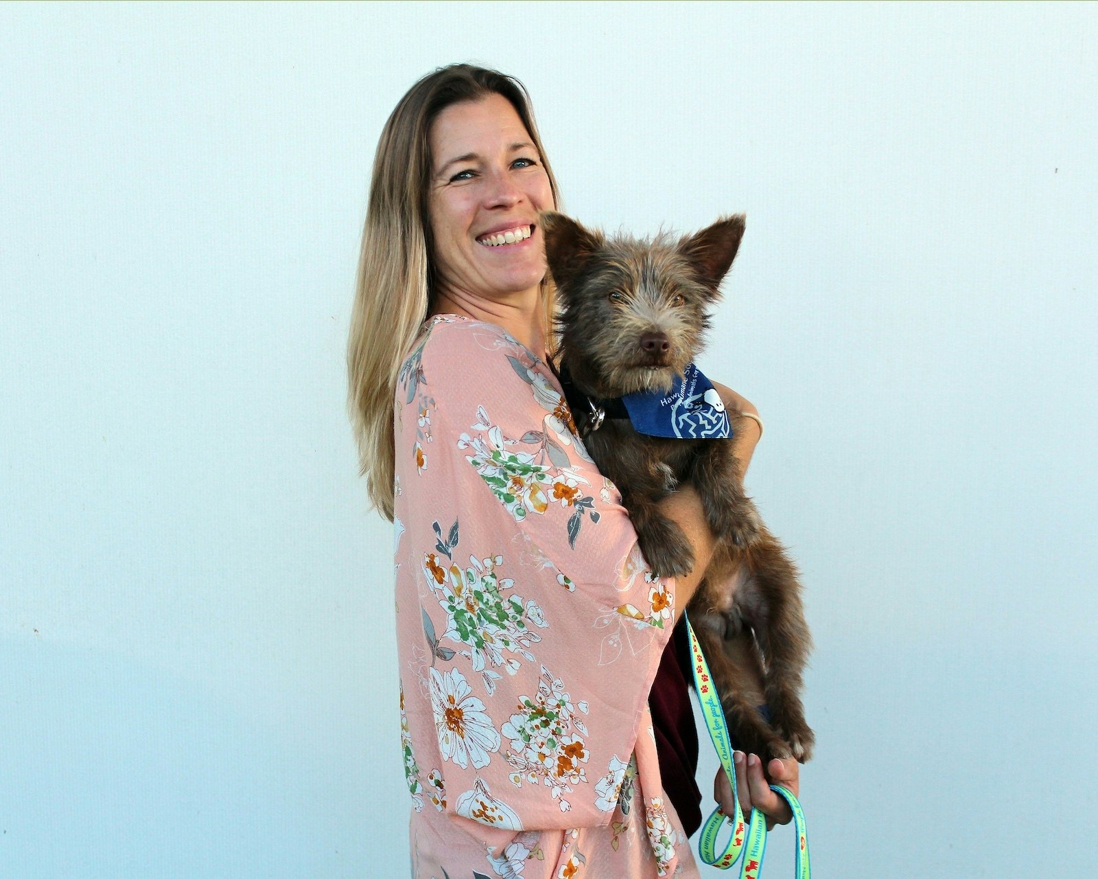 Woman holding a dog.