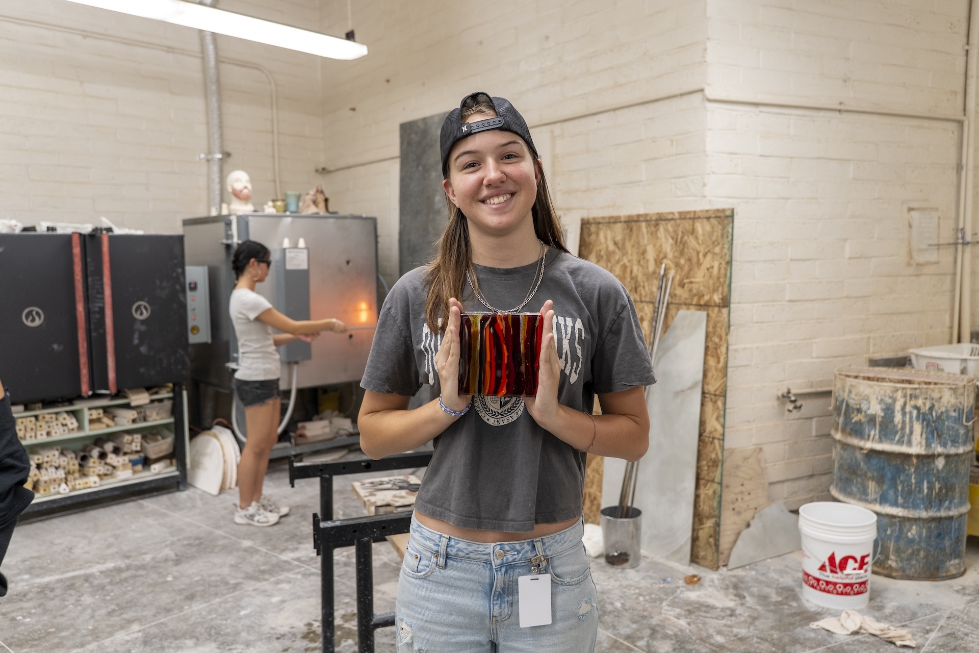 Leilehua High School 12th grader Ariana Wilhite poses with handmade glass piece.