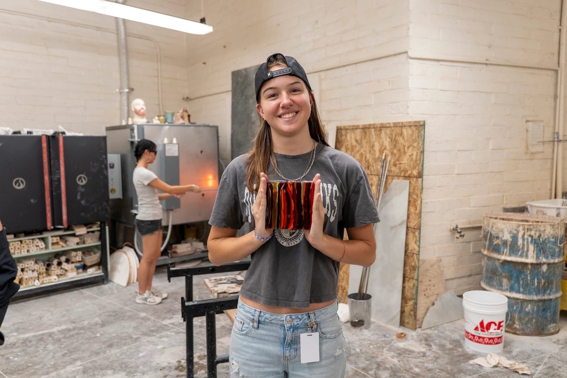 Leilehua High School 12th grader Ariana Wilhite poses with handmade glass piece.
