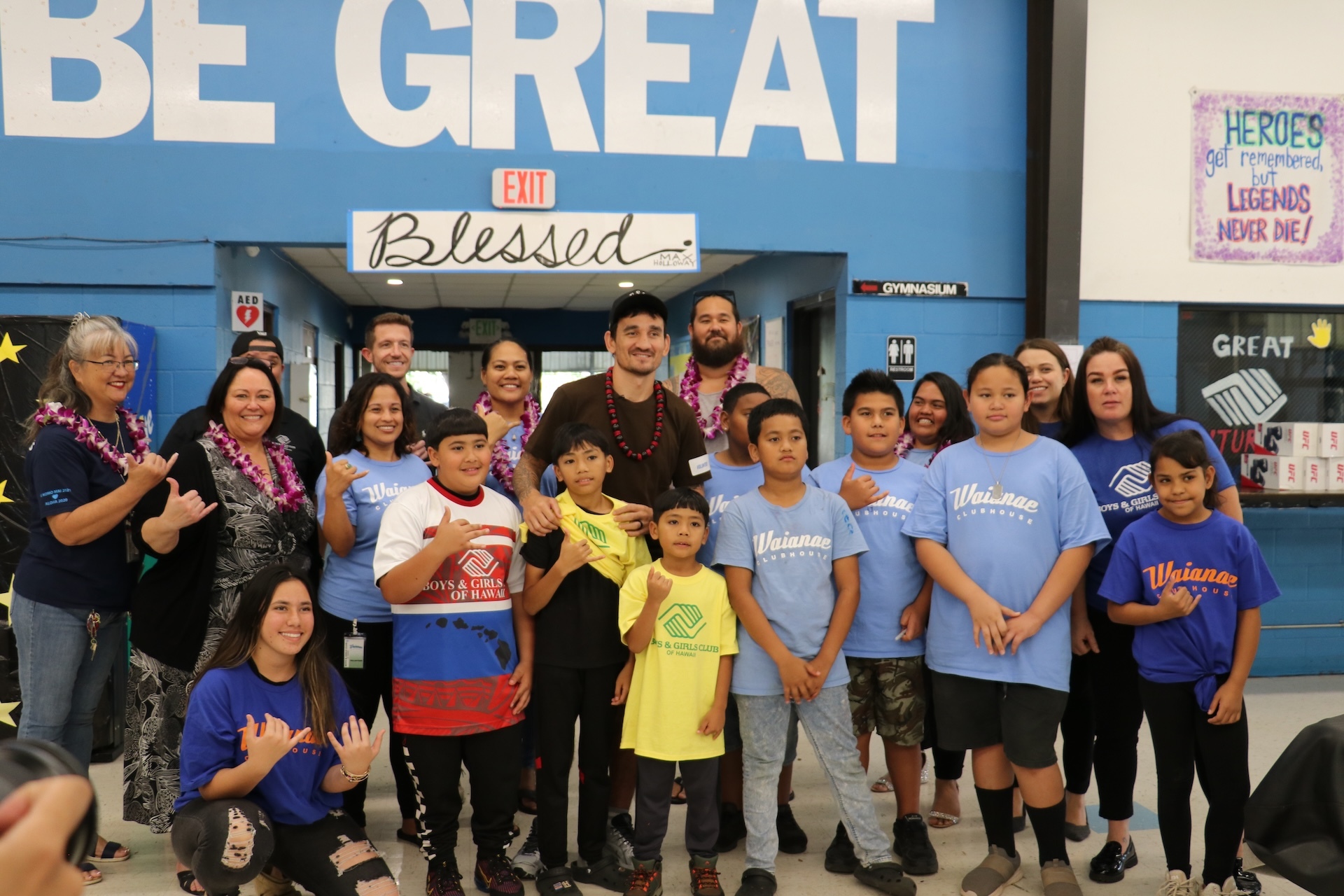 Memories of BGCH over the past five decades: Waiʻanae mixed martial artist Max Holloway, center; BGCH President and CEO Paddy Kauhane, second from left, and keiki.