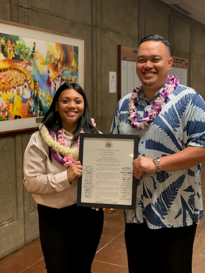 Ladayna Aranas holding the state award.