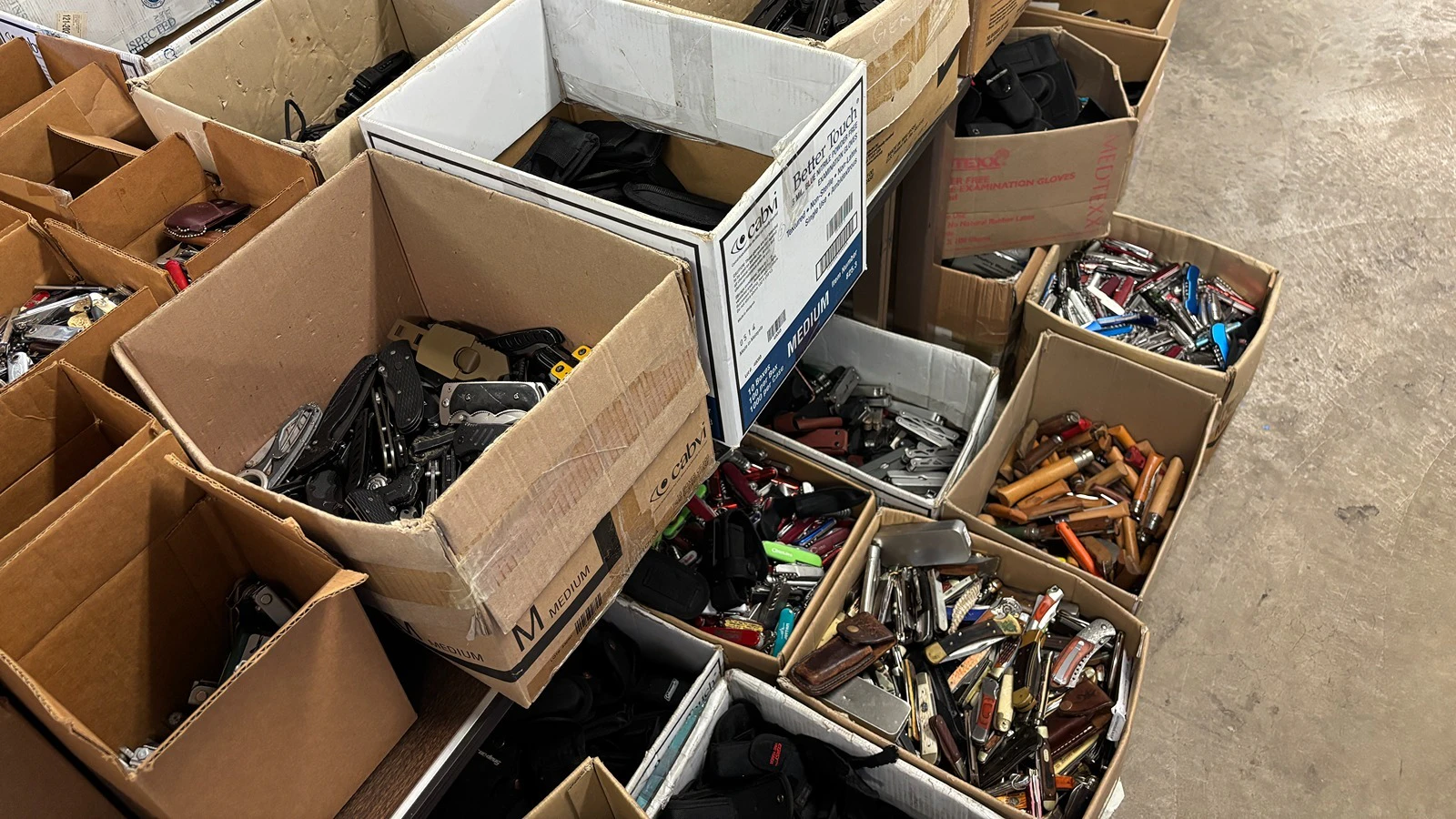 Boxes of surrendered knives at the state Surplus Property Office.