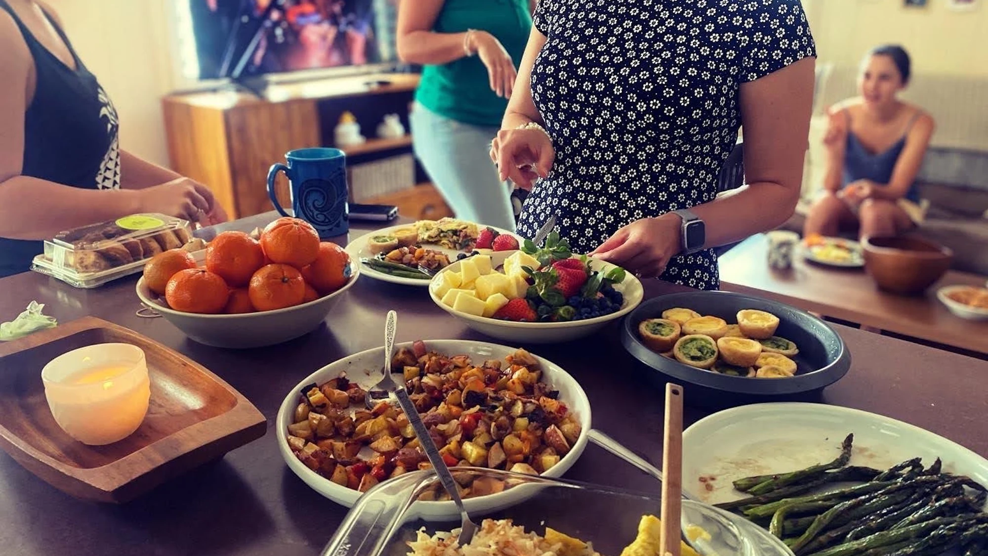 Food spread on a table a someone hosting in their home.