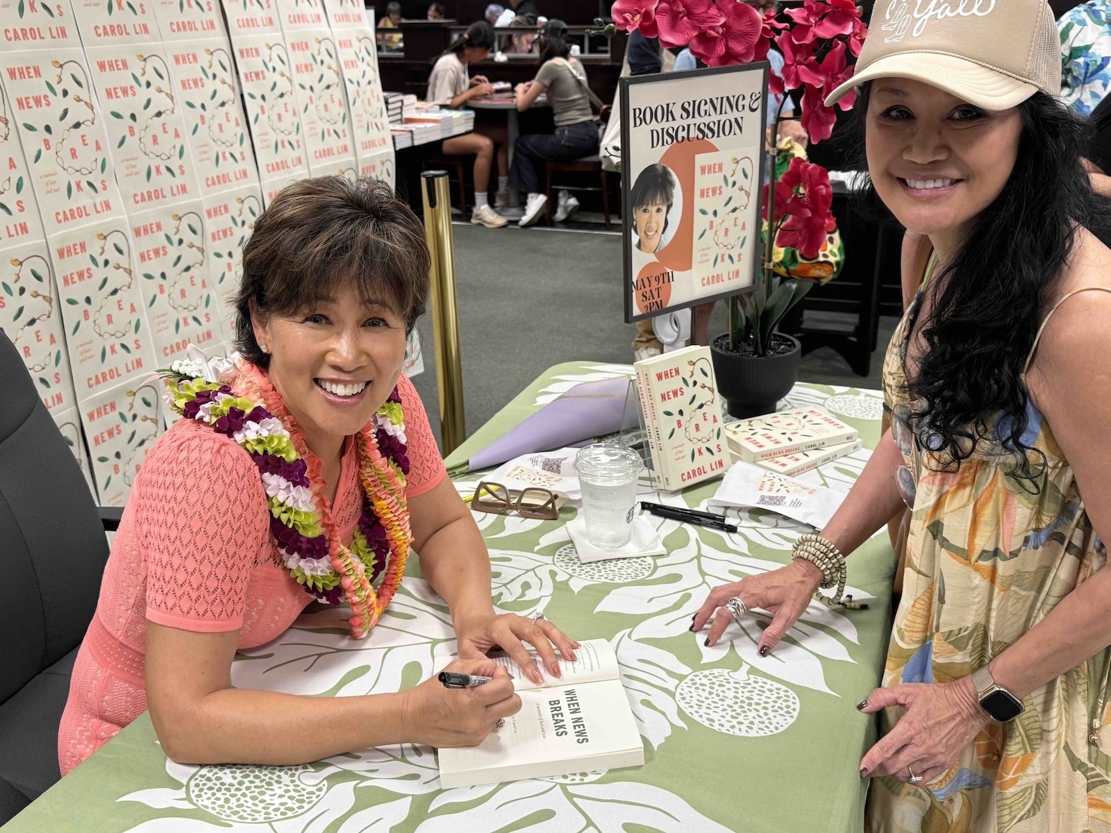 Carol Lin, left, signs a copy of “When News Breaks: A Memoir of Love and War” at an author event at Barnes & Noble in Ala Moana Center earlier this year.