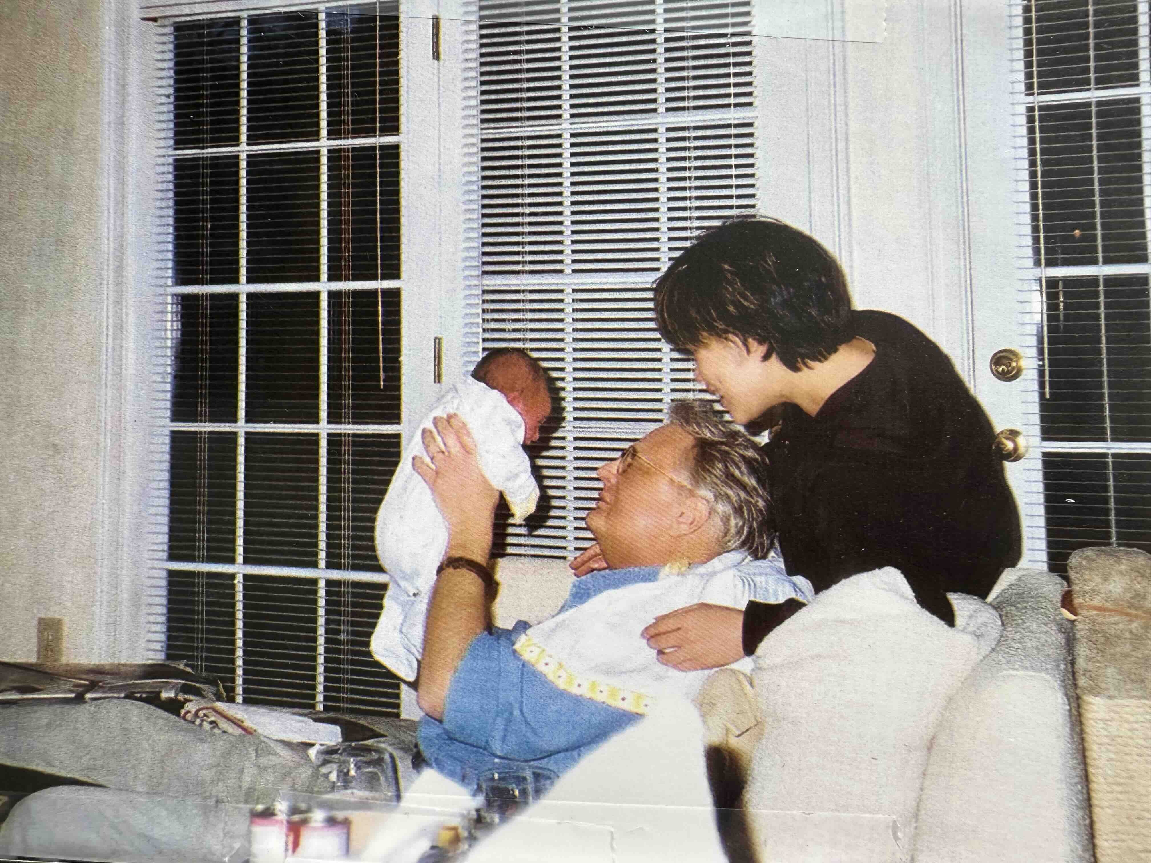 Will Robinson and Carol Lin hold newborn baby, Chloe. Robinson was diagnosed with cancer while Lin was pregnant and died shortly after their daughter was born.