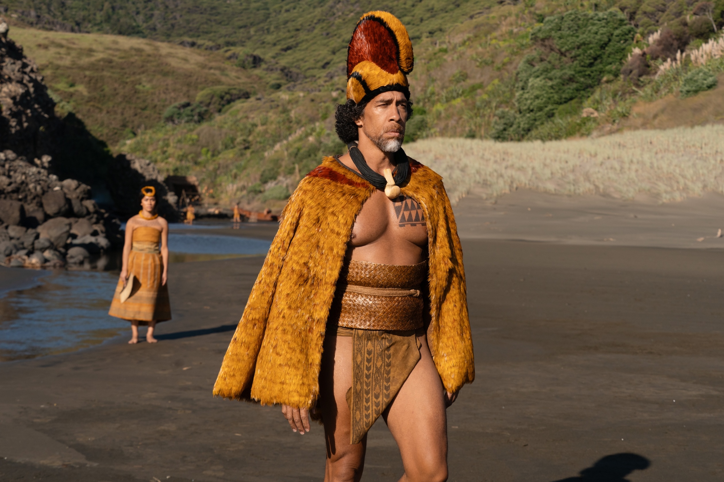Moses Goods plays the role of Moku, advisor to the future King Kamehameha I. He offers his daughter, Kaʻahumanu, played by actress Luciane Buchanan, shown here on the beach, in marriage to him.