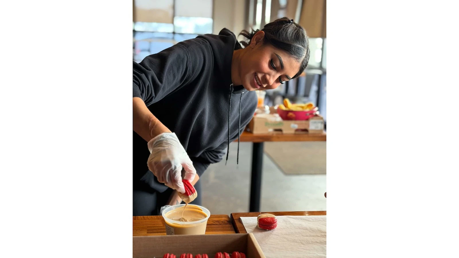 Daniela Fry dips a macaron