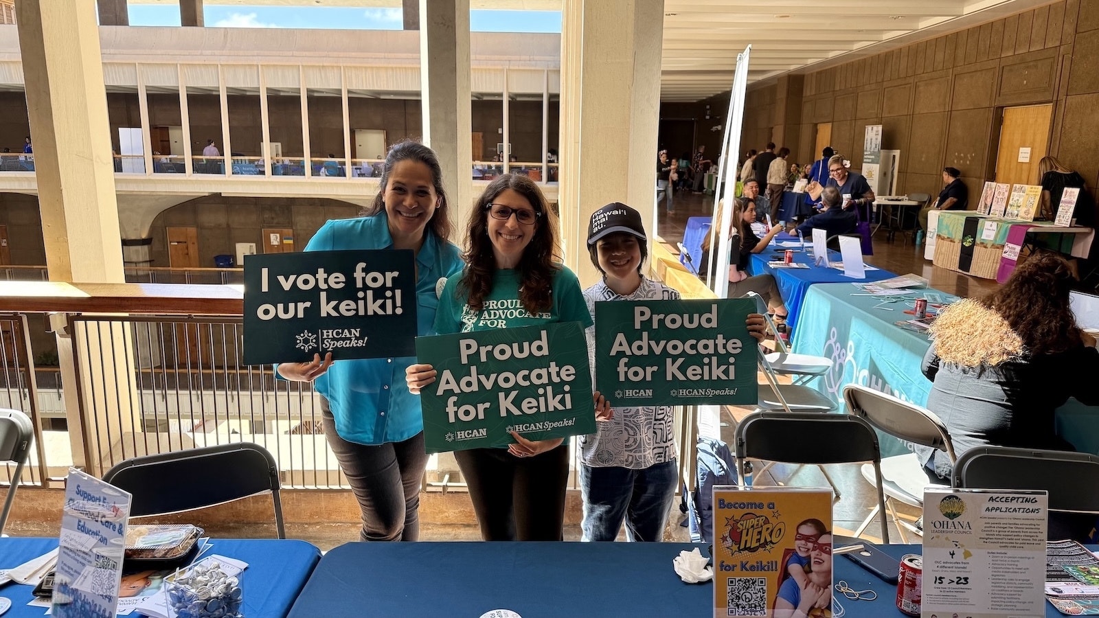 Team holding up signs for keiki.