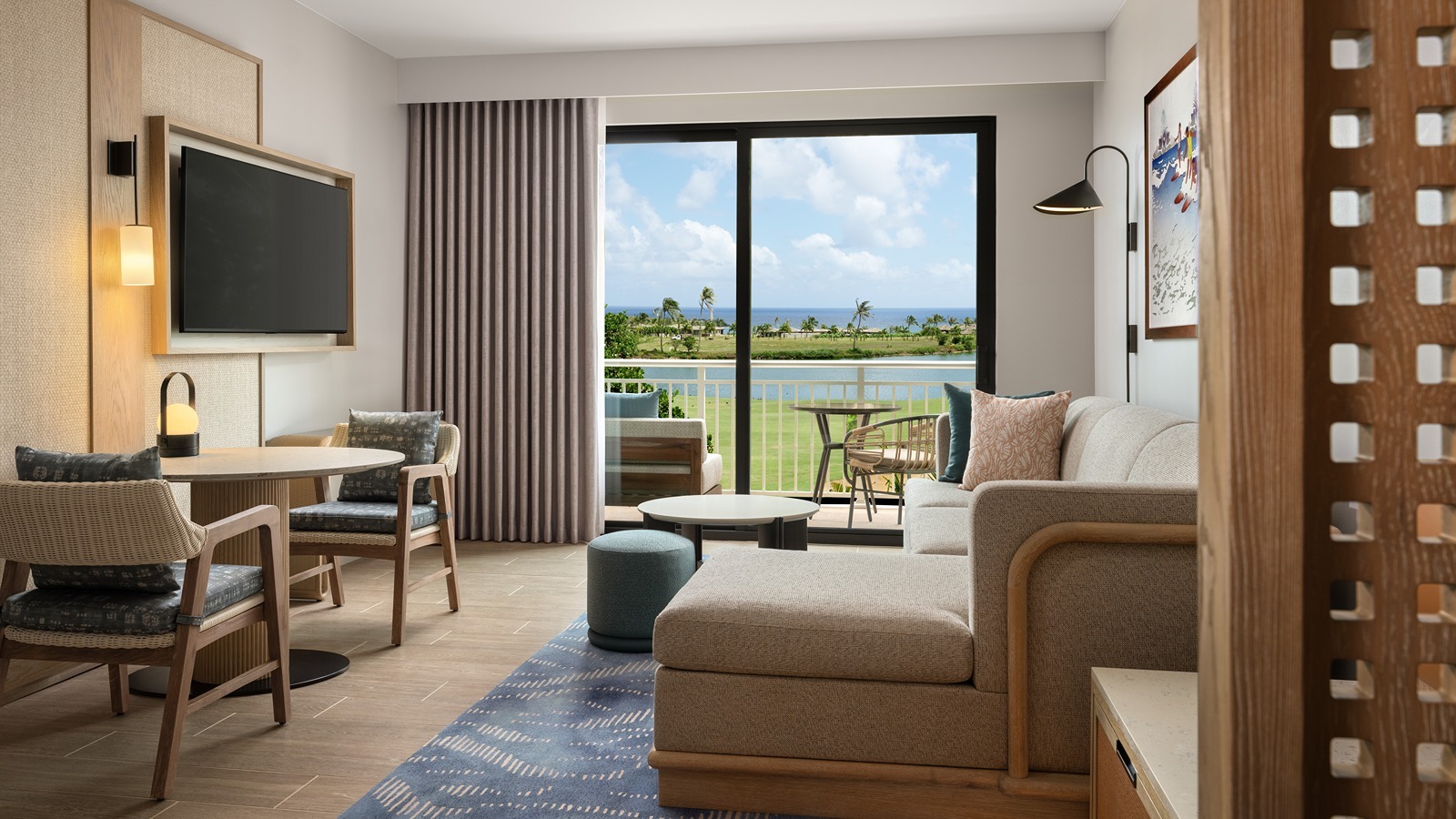 The living room of a king suite at Hale Hōkūala Kaua‘i, Curio Collection by Hilton