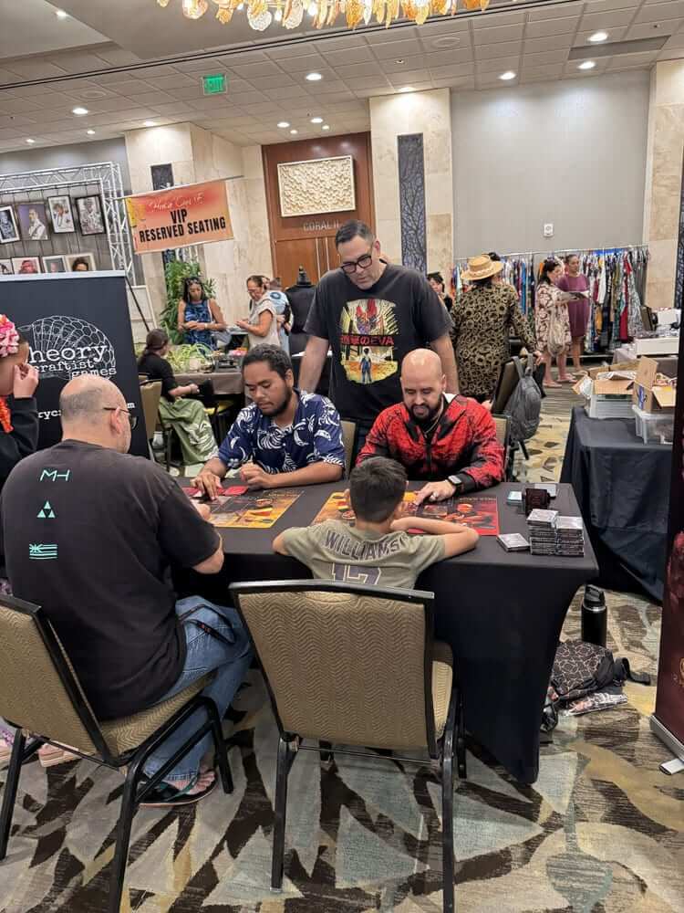 Jack Hobbs (left) and Alika Spahn Naihe (right) demonstrate how Hoa Kaua is played at the Hula ʻOni E festival in August. Standing behind them is Jeffrey Vierra.