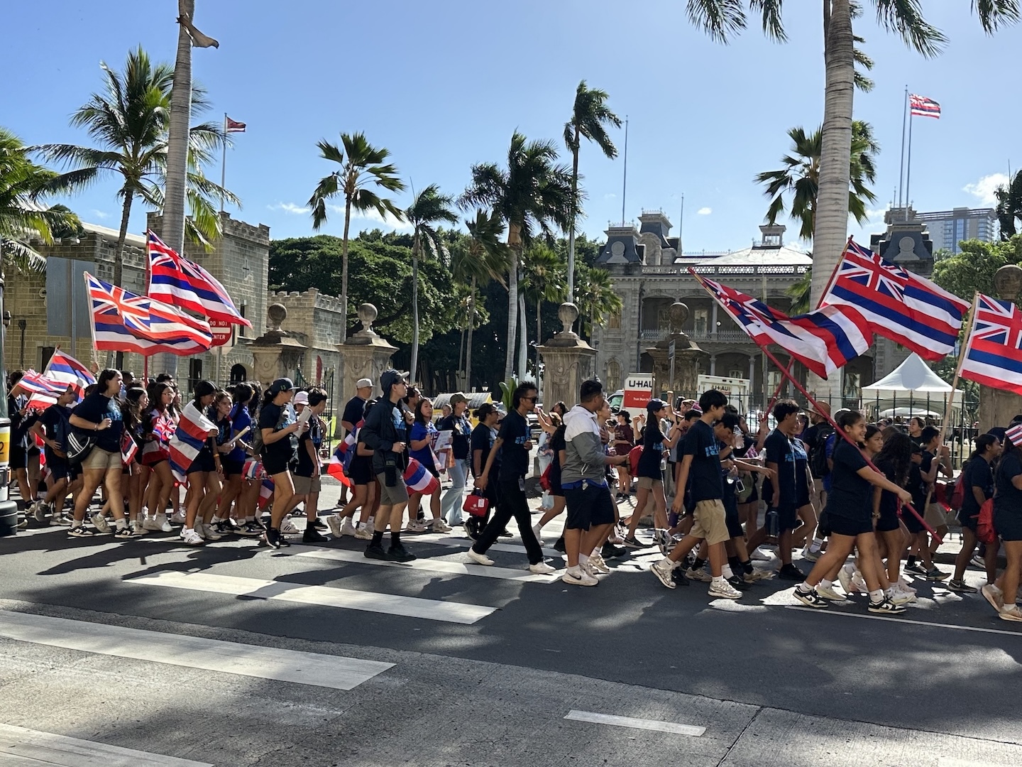 Keiki held flags as part of the ʻOnipaʻa Peace March on Friday, Jan. 16.
