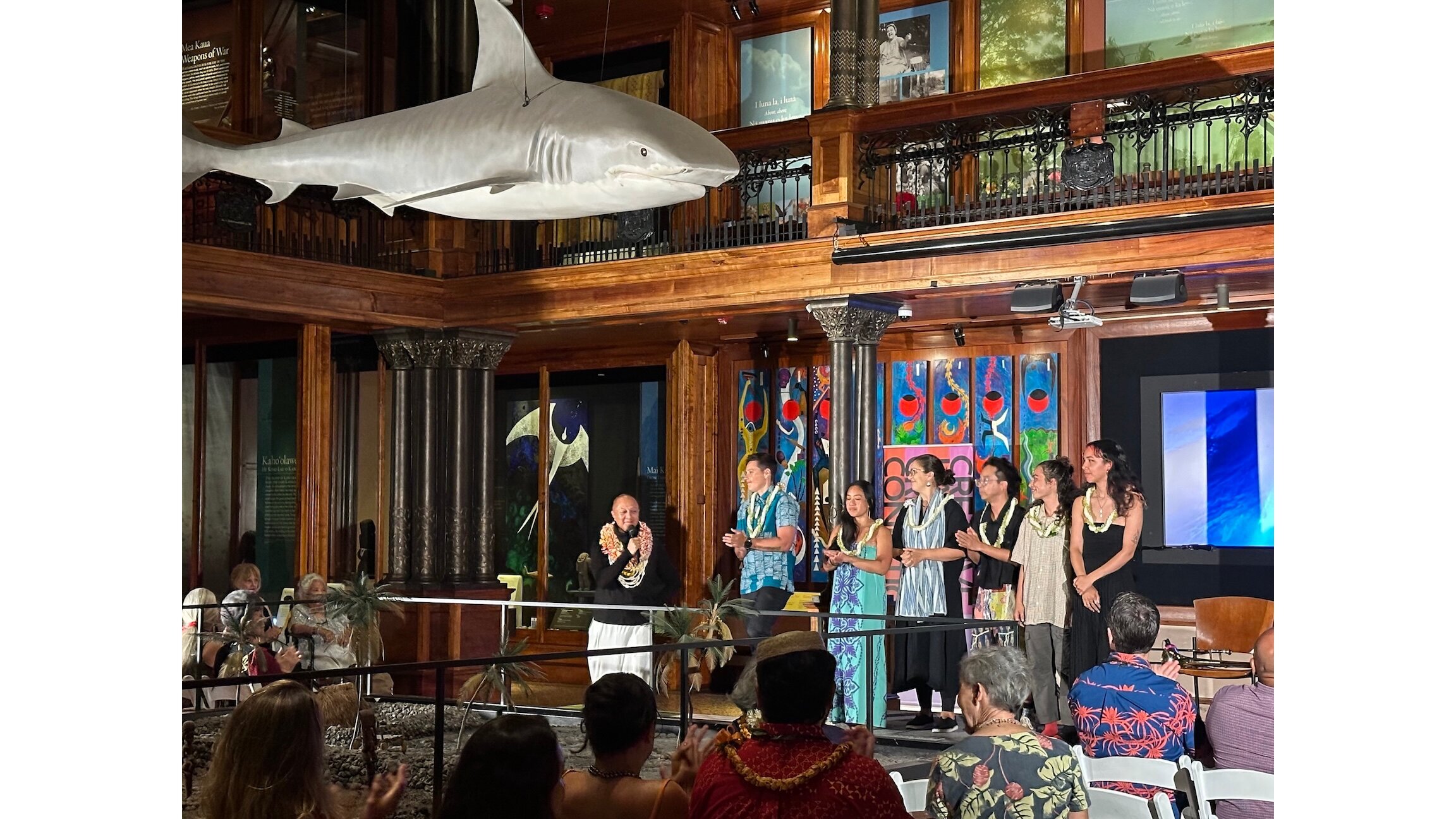 Christopher Kaui Morgan, left, recognizes the six artists who are part of Wehiwehiʻs second cohort after their showcase at the Bishop Museum.