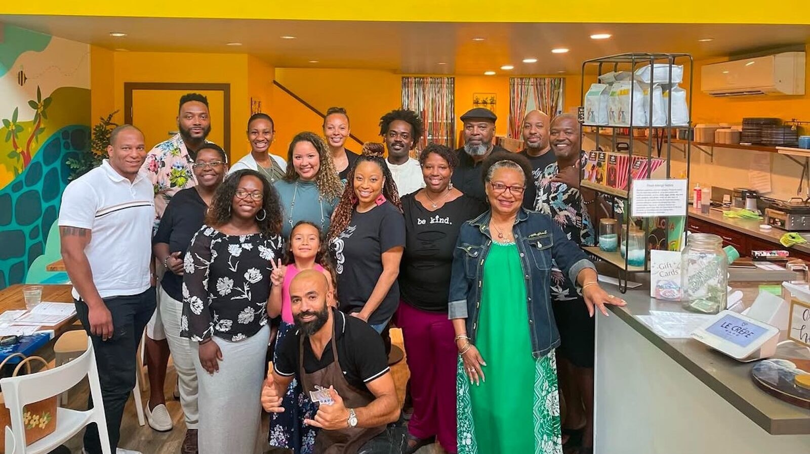 A group poses at a crepe shop.