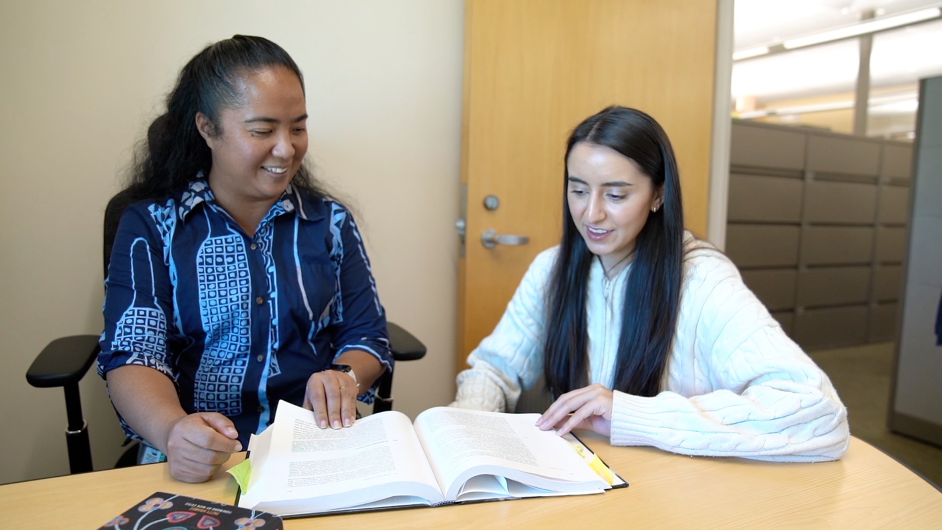 JABSOM's Kelsea Kanoho Hosoda, left, with student Alisha Suri.