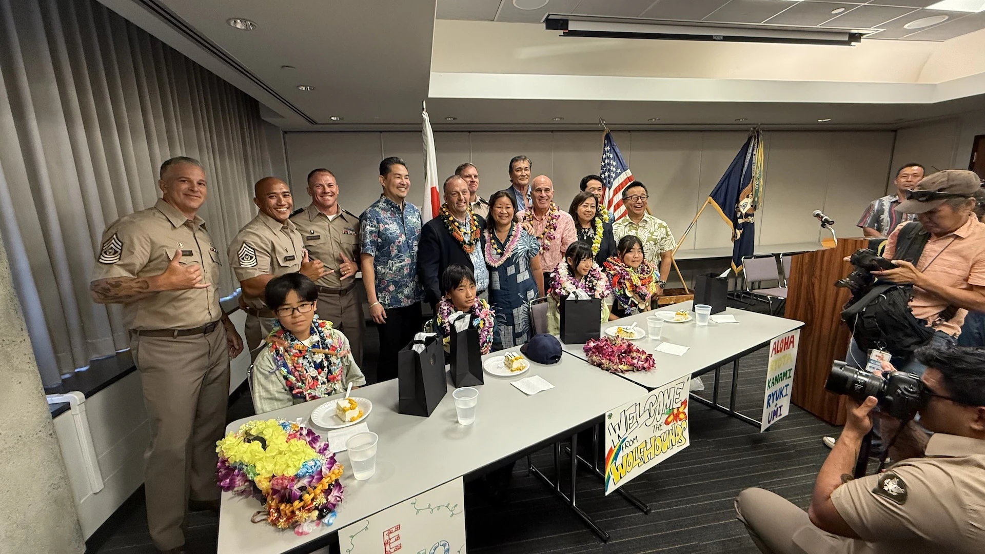 Dignitaries and military personnel pictured with four 11-year-old children from Holy Family Home, an orphanage in Osaka, Japan, at Daniel K. Inouye International Airport on Monday, Aug. 18.