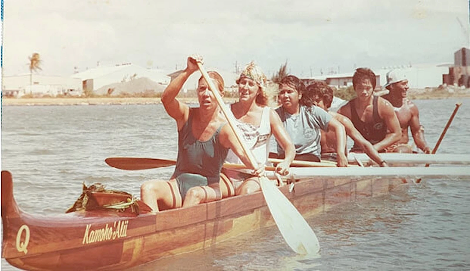 A mixed crew of paddlers from the Waikīkī Beachboys take Kamoho Ali‘i for a ride in the early 1980s. The koa canoe has been in dry dock for more than two decades, but fundraising efforts to restore the canoe are currently underway. - Courtesy Photo