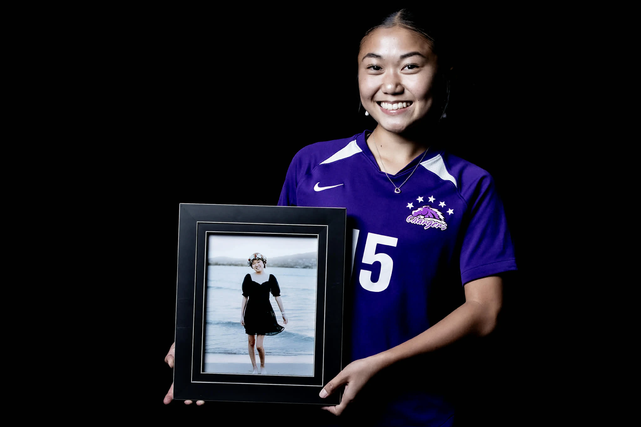 Pearl City sophomore Keely Tamayose poses with a photo of her late sister, Ally.