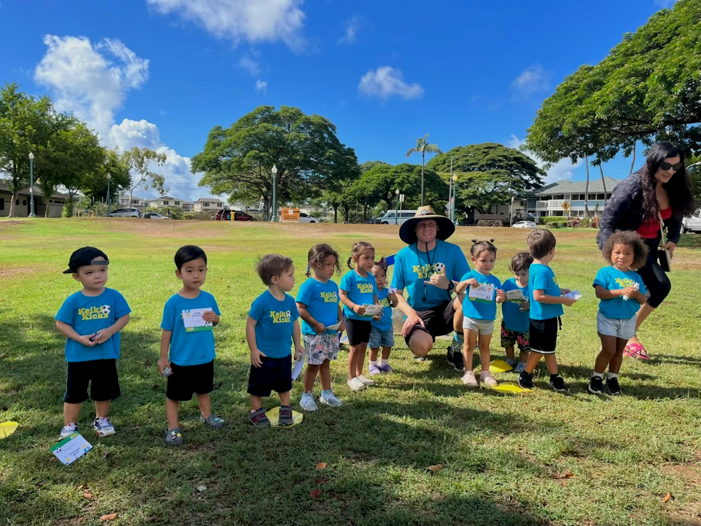 Young soccer players pose with coach Alex.