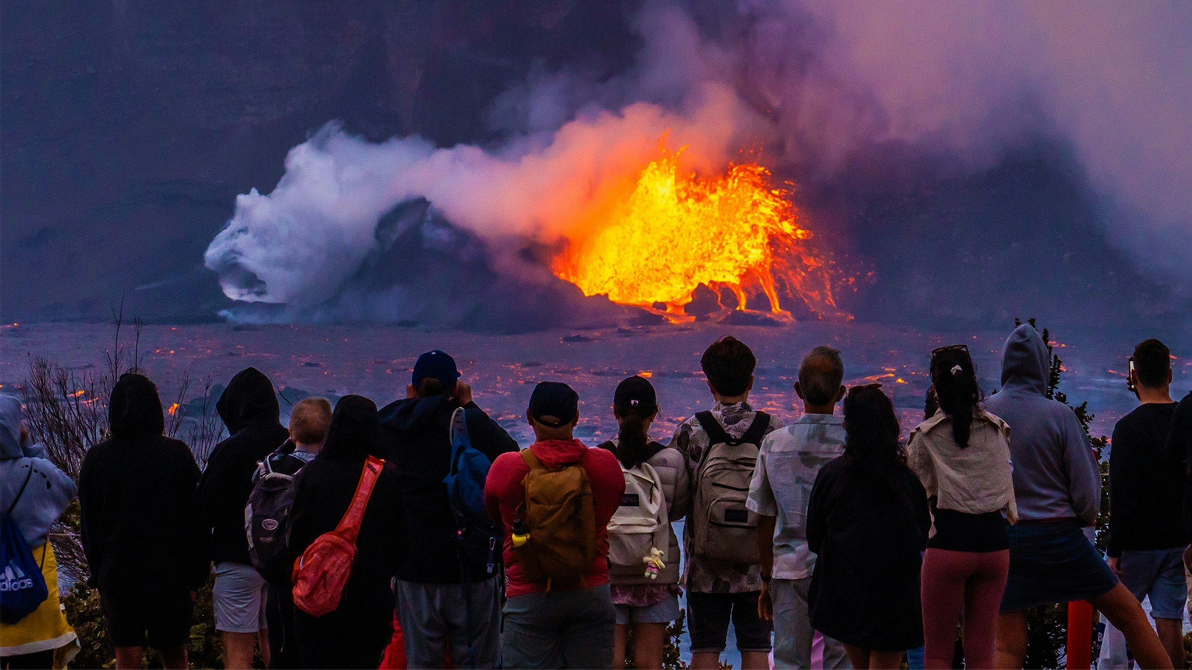 Visitors view the eruption of Kīlauea volcano.