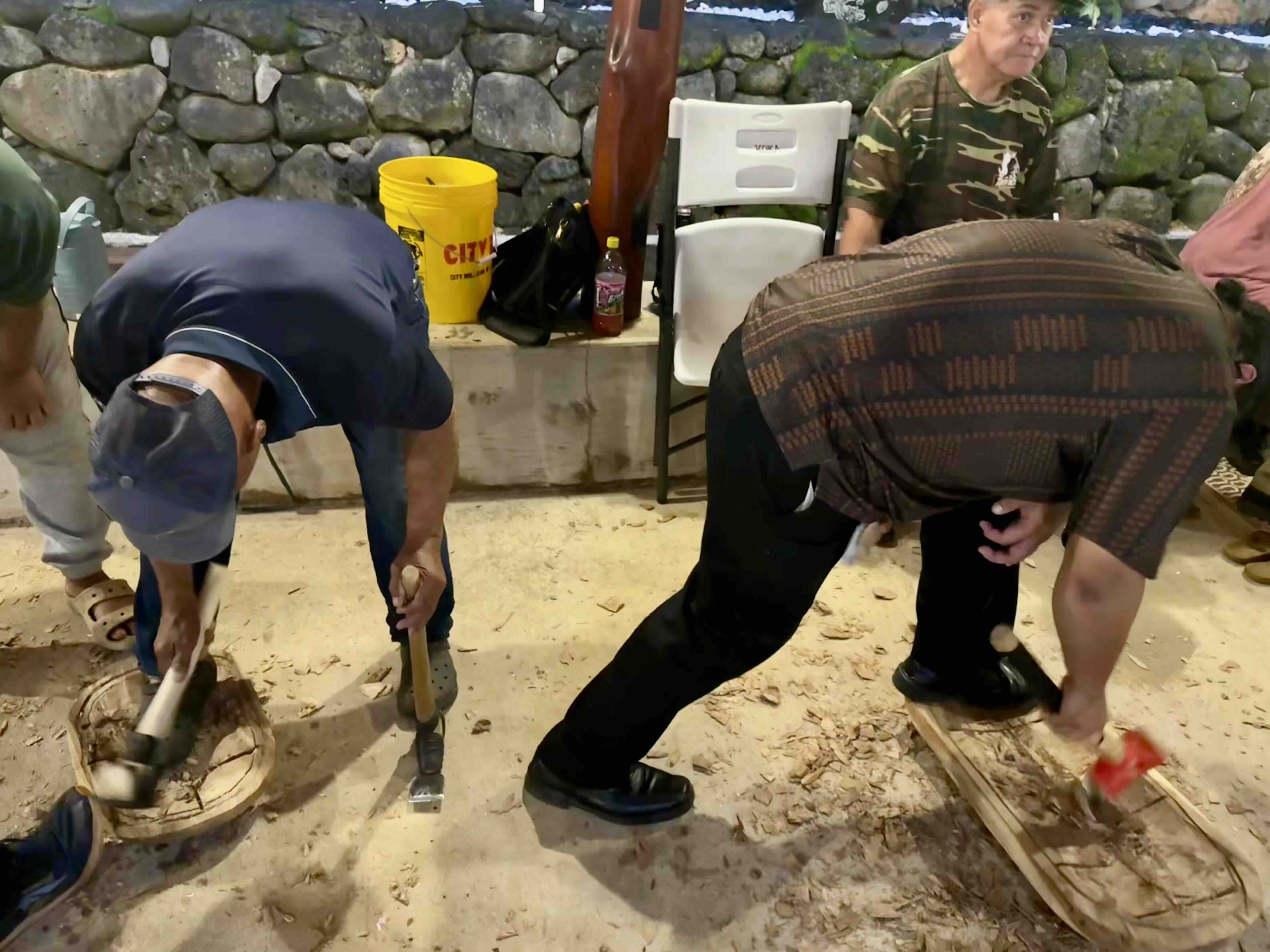 Kawa'a, left, works on papa side by side with ʻohana from this spring's KOKA Board and Stone class.