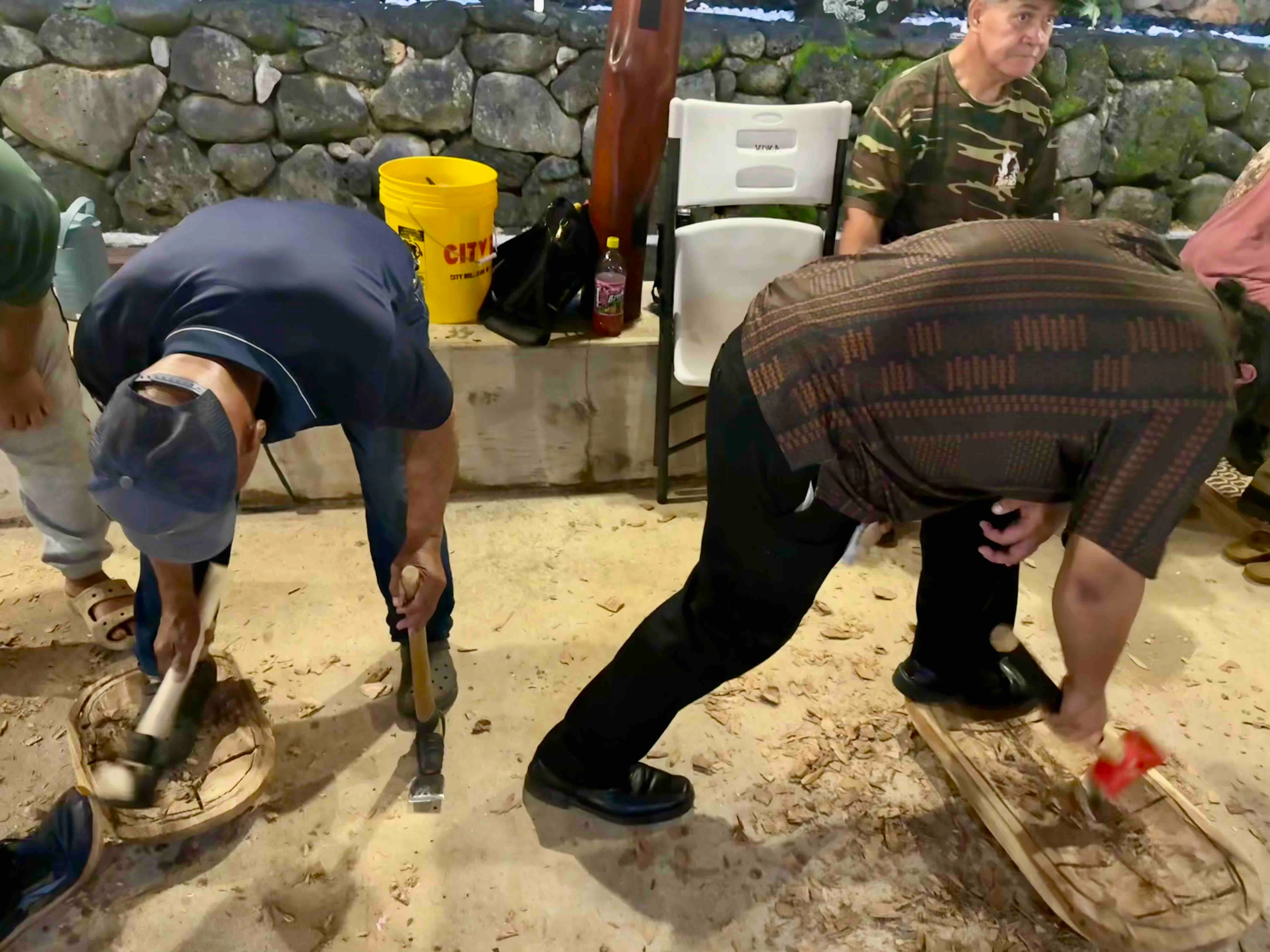 Kawa'a, left, works on papa side by side with ʻohana from this spring's KOKA Board and Stone class.