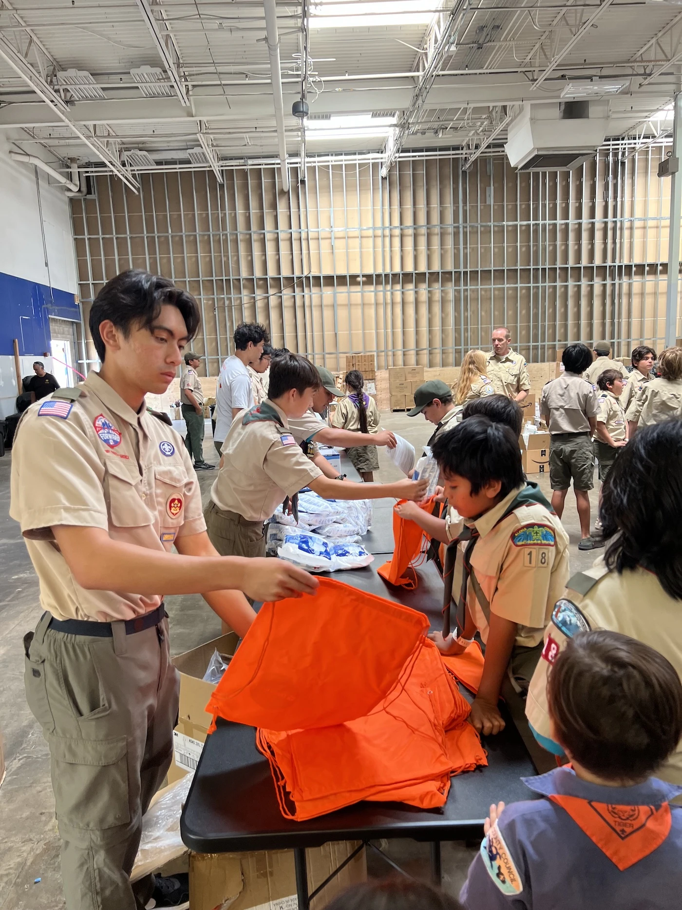 Noah Kalehuawehe, left, works with fellow Scouts to support the community following the 2023 Lahaina fire.