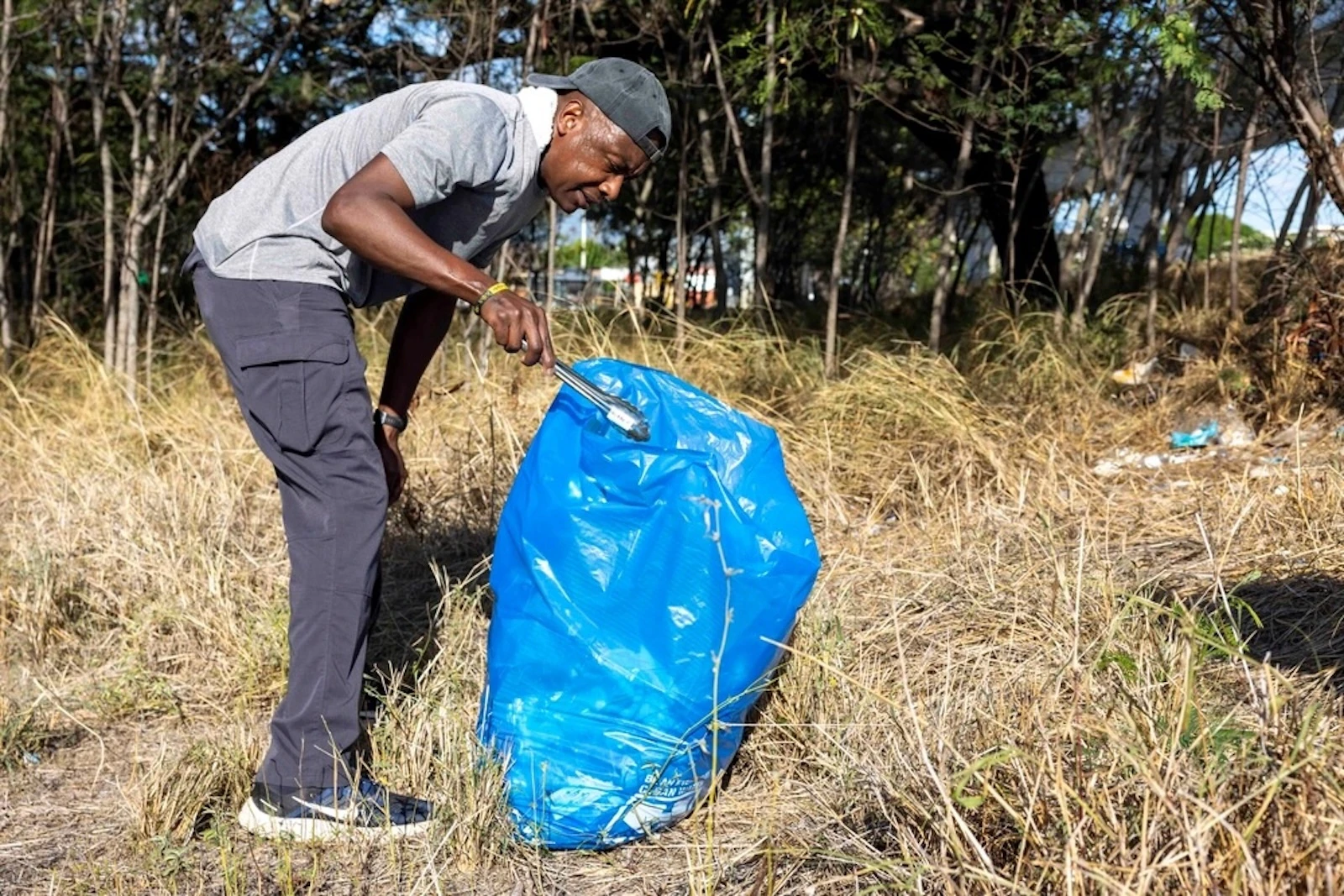 Rear Adm. Stephen Barnett, commander of Navy Region Hawai'i, picks up trash along the Pearl Harbor Bike Path that runs along Pearl Harbor's historic waterfront in Aiea.