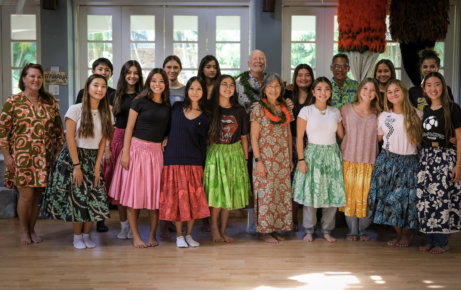 Pūpūkahi I Ke Alo O Nā Pua dancers with Mid-Pacific Vice President of Institutional Advancement Shannon Cleary, left, Stephen and Gloria Gainsley, middle, and Kumu Hula Michael Lanakila Casupang, back right.
