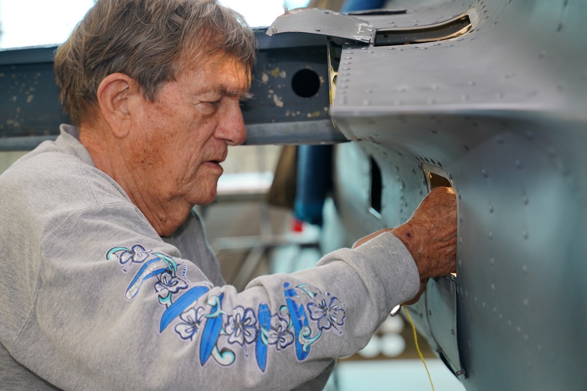 Montgomery disassembles a stabilizer on the tail section of an SBD-5 Dauntless, a World War II-era dive bomber. Credit: PHAM.