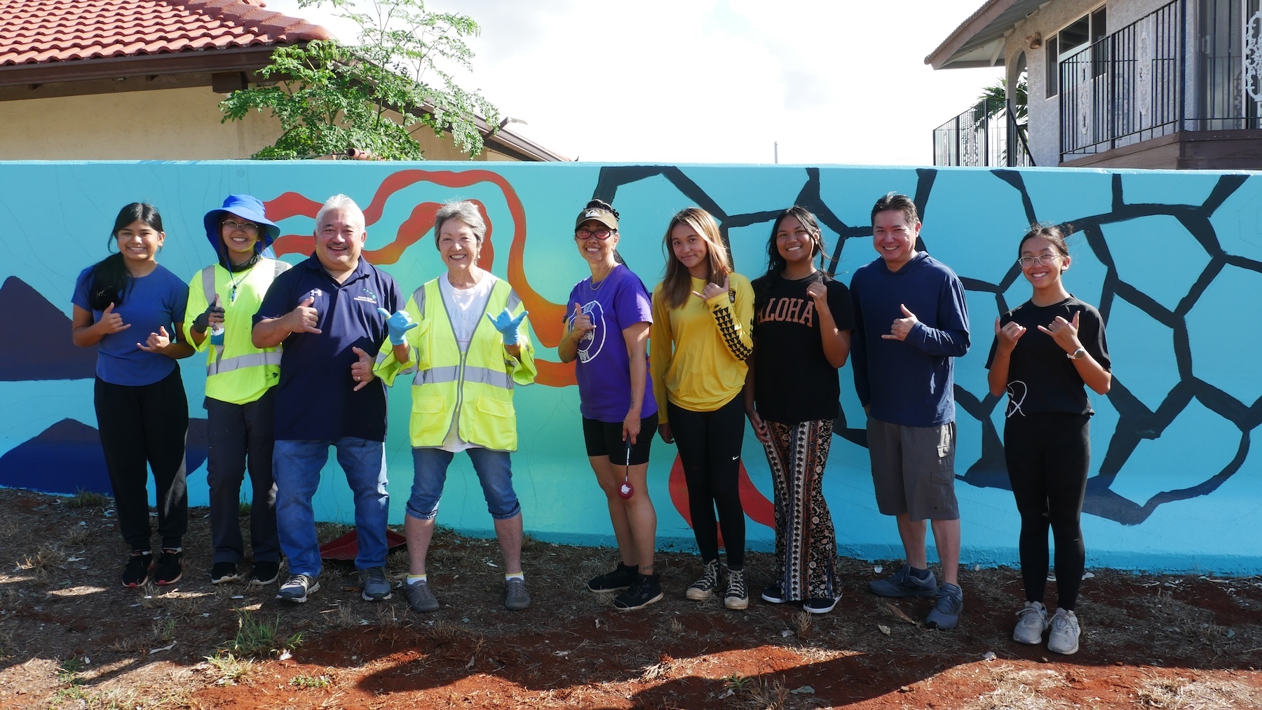 Students joined Senator Michelle Kidani (fourth from the left) and Keith Hayashi (third from left), the superintendent of the Hawaiʻi State Department of Education, to work on the mural.