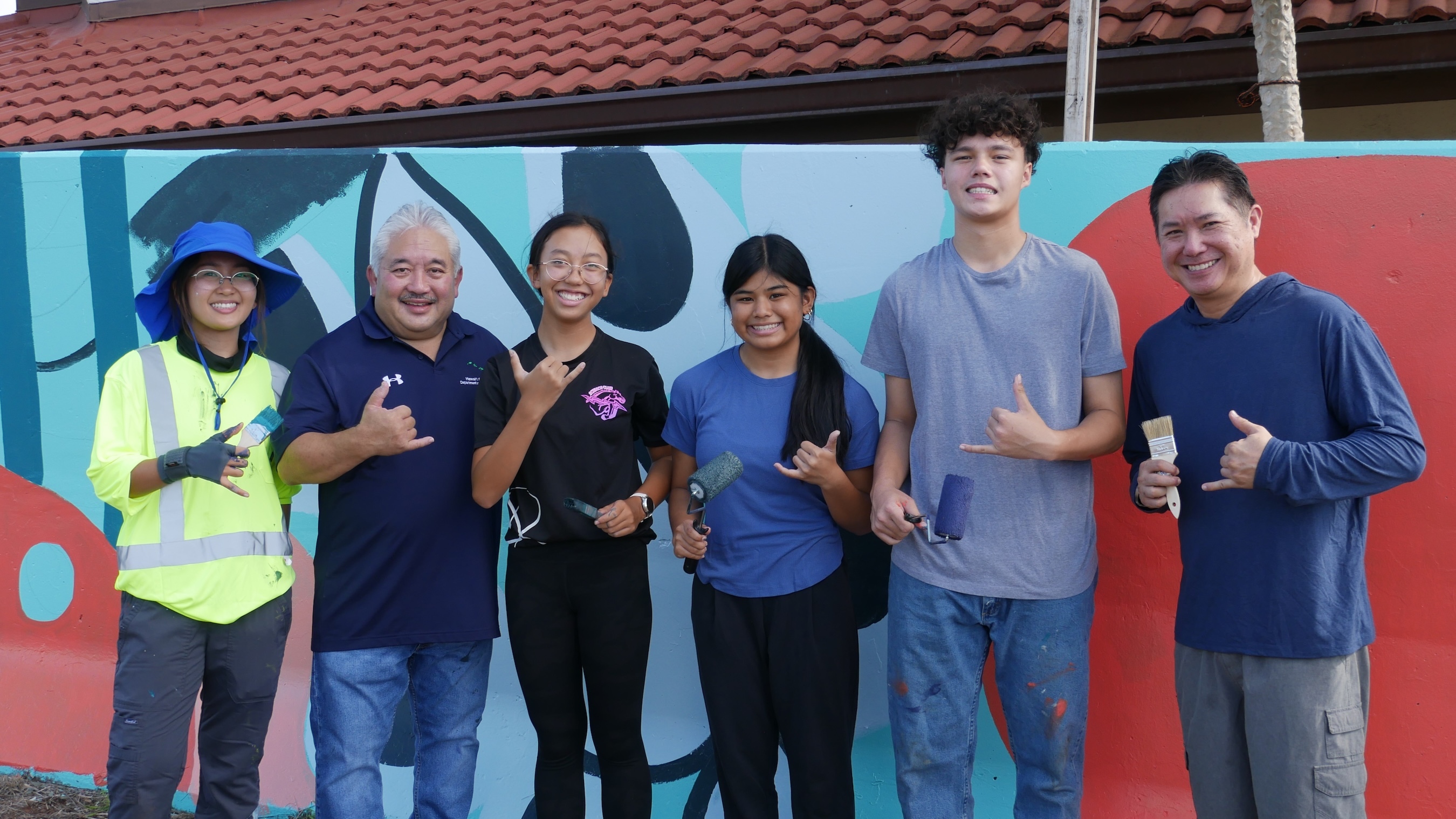 Keith Hayashi (second from left), the superintendent for the Hawaiʻi State Department of Education, joined students in working on the mural.