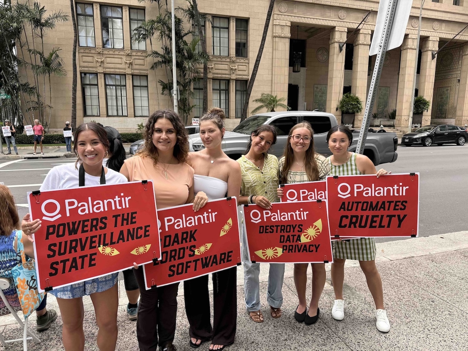 Catherine Titzer, left, who recently graduated from Stanford University and is now a community field fellow for ACLU of Hawaiʻi, pictured with Palantir protesters.  Photo by Kelsey Kukaua Medeiros