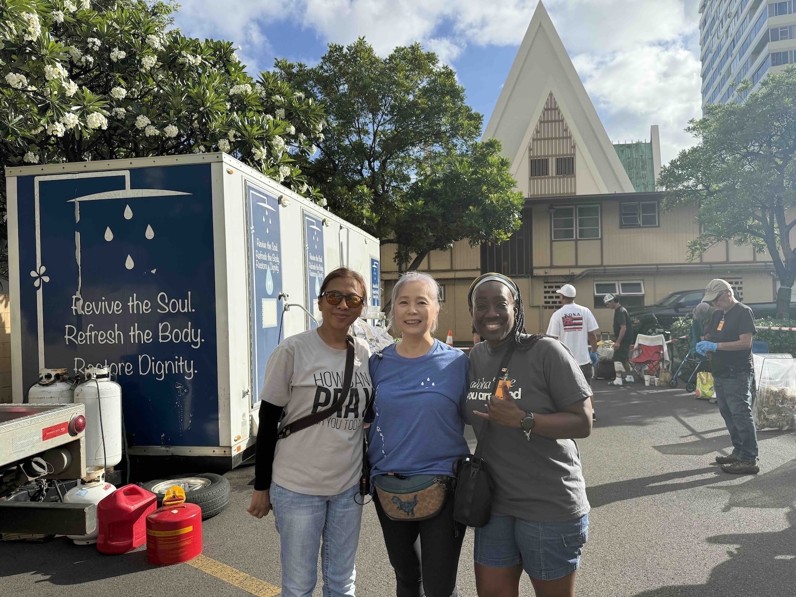 Danica, center, runs Revive + Refresh, a shower and laundry service. Photo by Kelsey Kukaua Medeiros
