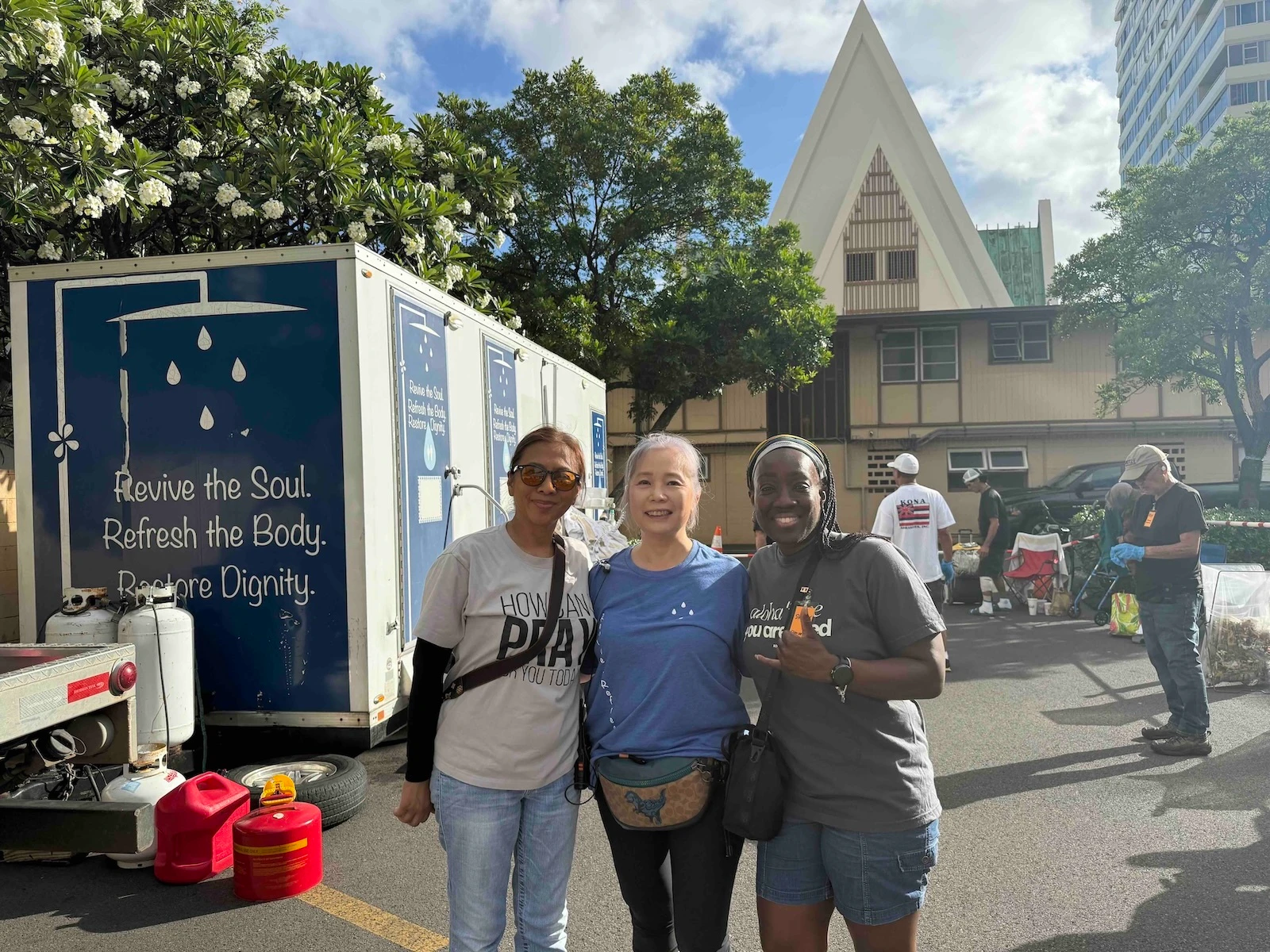 Danica, center, runs Revive + Refresh, a shower and laundry service. Photo by Kelsey Kukaua Medeiros