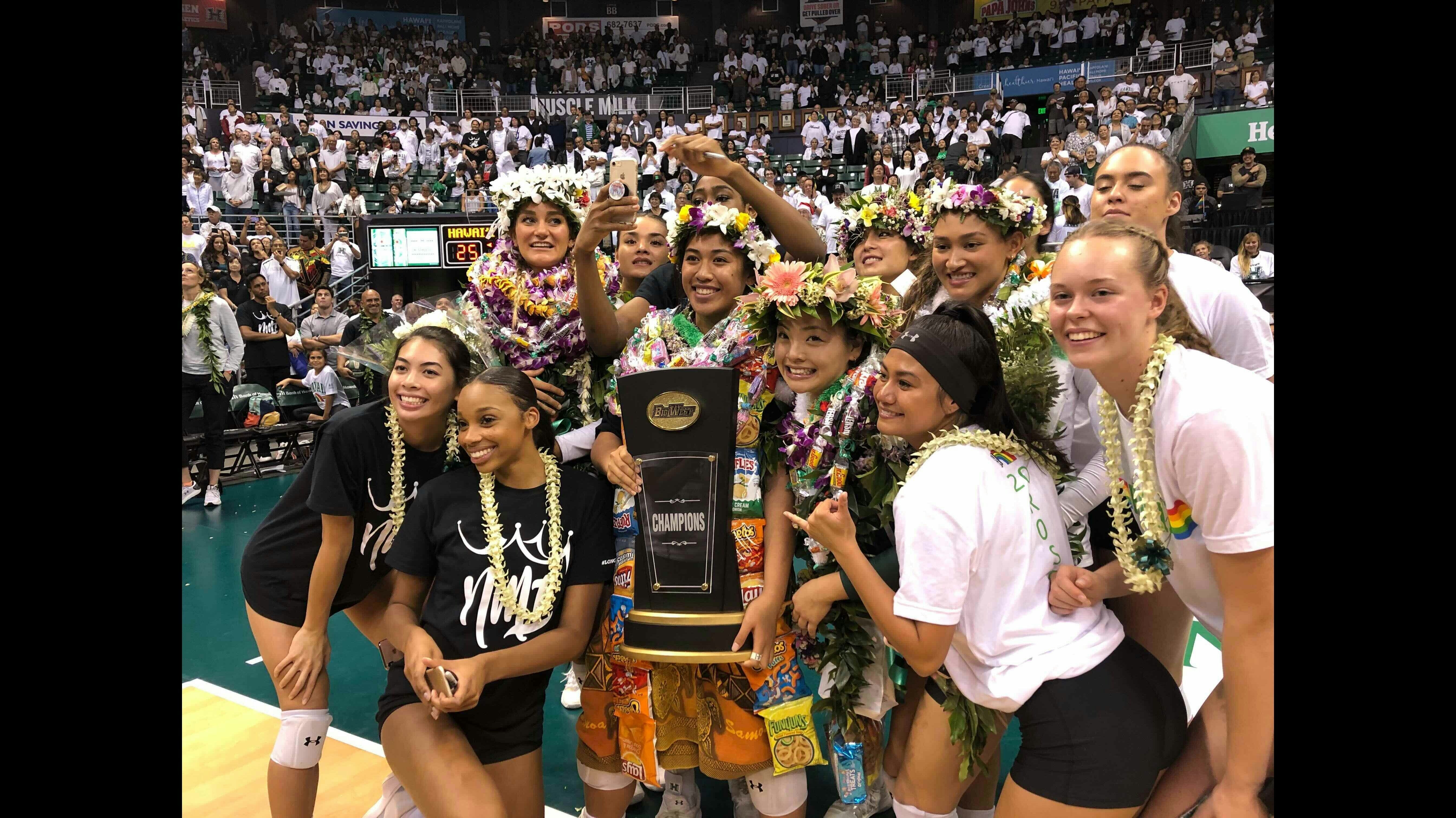 Members of the University of Hawaii women's volleyball team celebrate a Big West Conference championship on senior night in 2019.