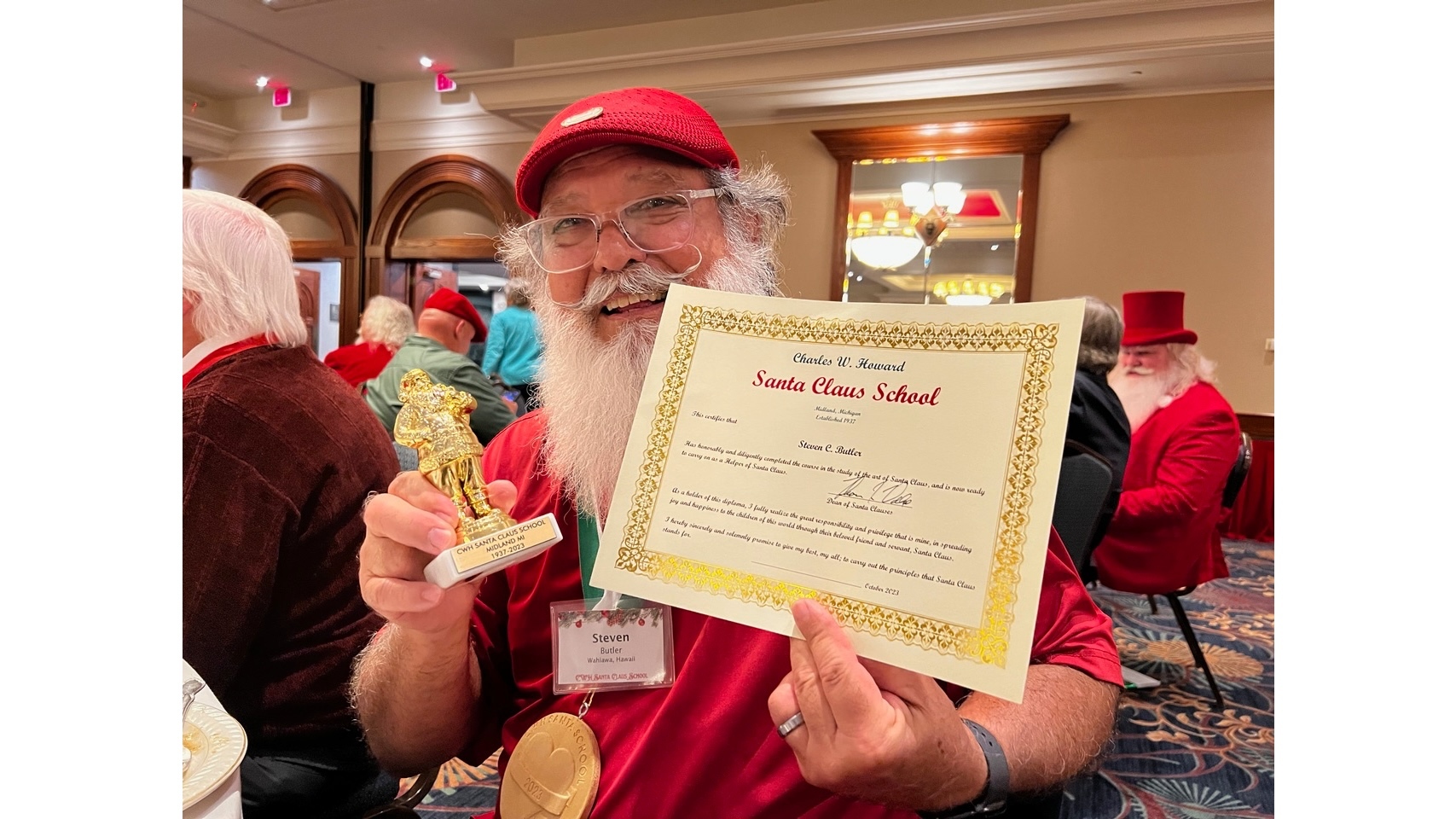 Butler displays the certificate he received when he graduated from the Charles W. Howard Santa Claus School in 2023.