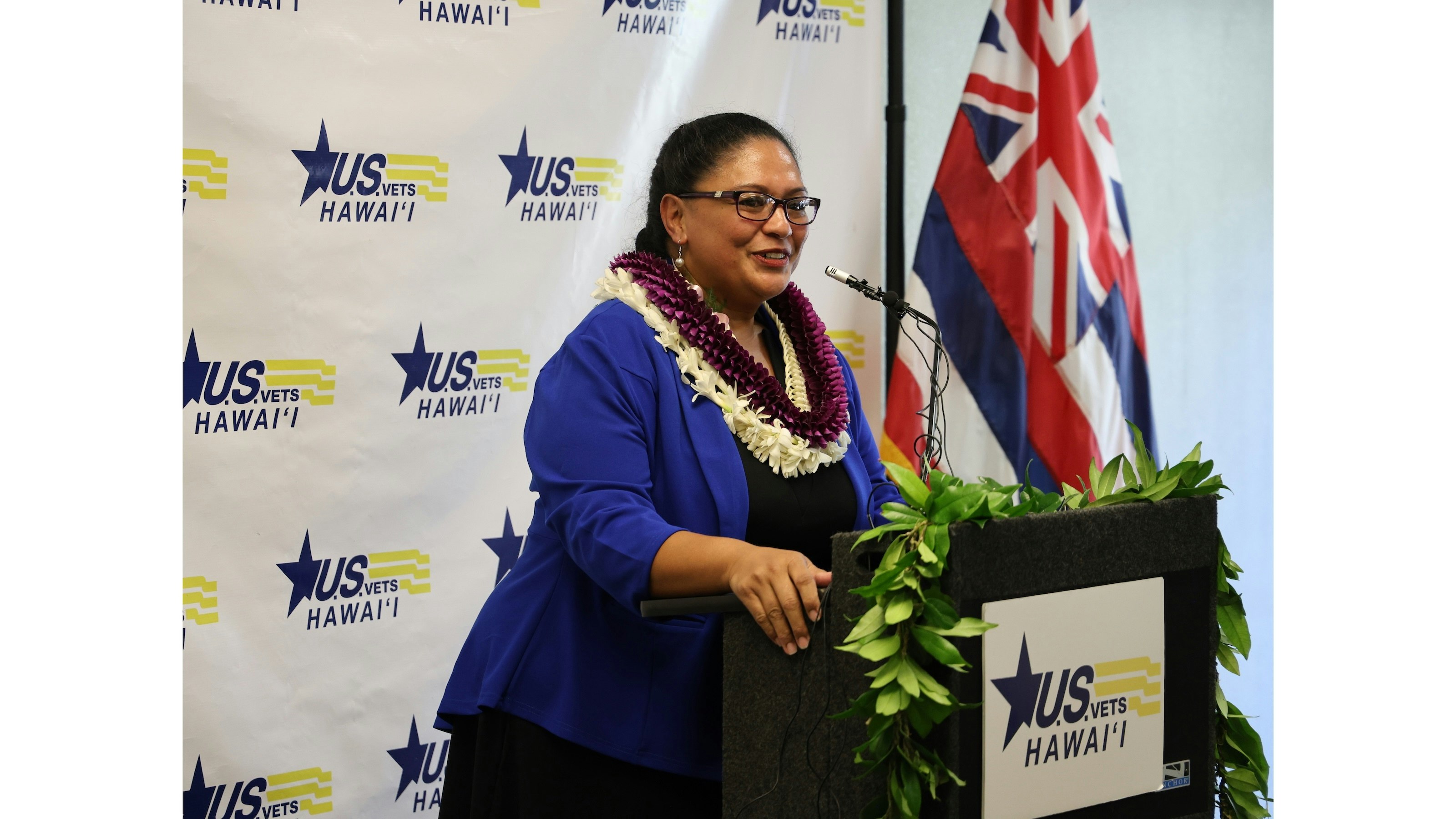 Woman standing at podium.