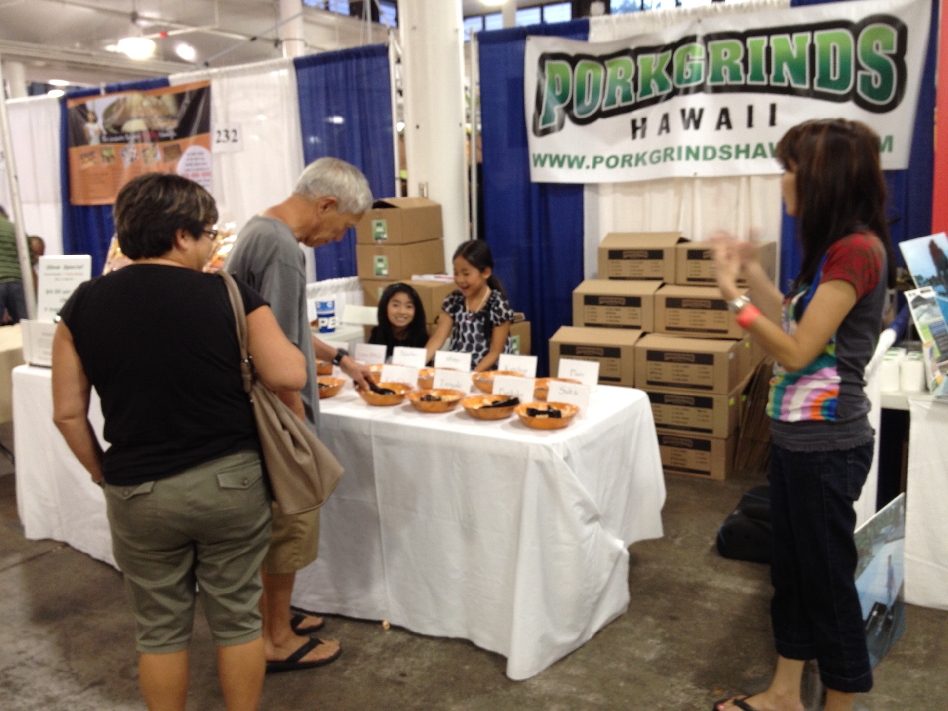 A young Taylor Yuen, back left, helps out at her family's business at Made in Hawaiʻi Festival in 2012.